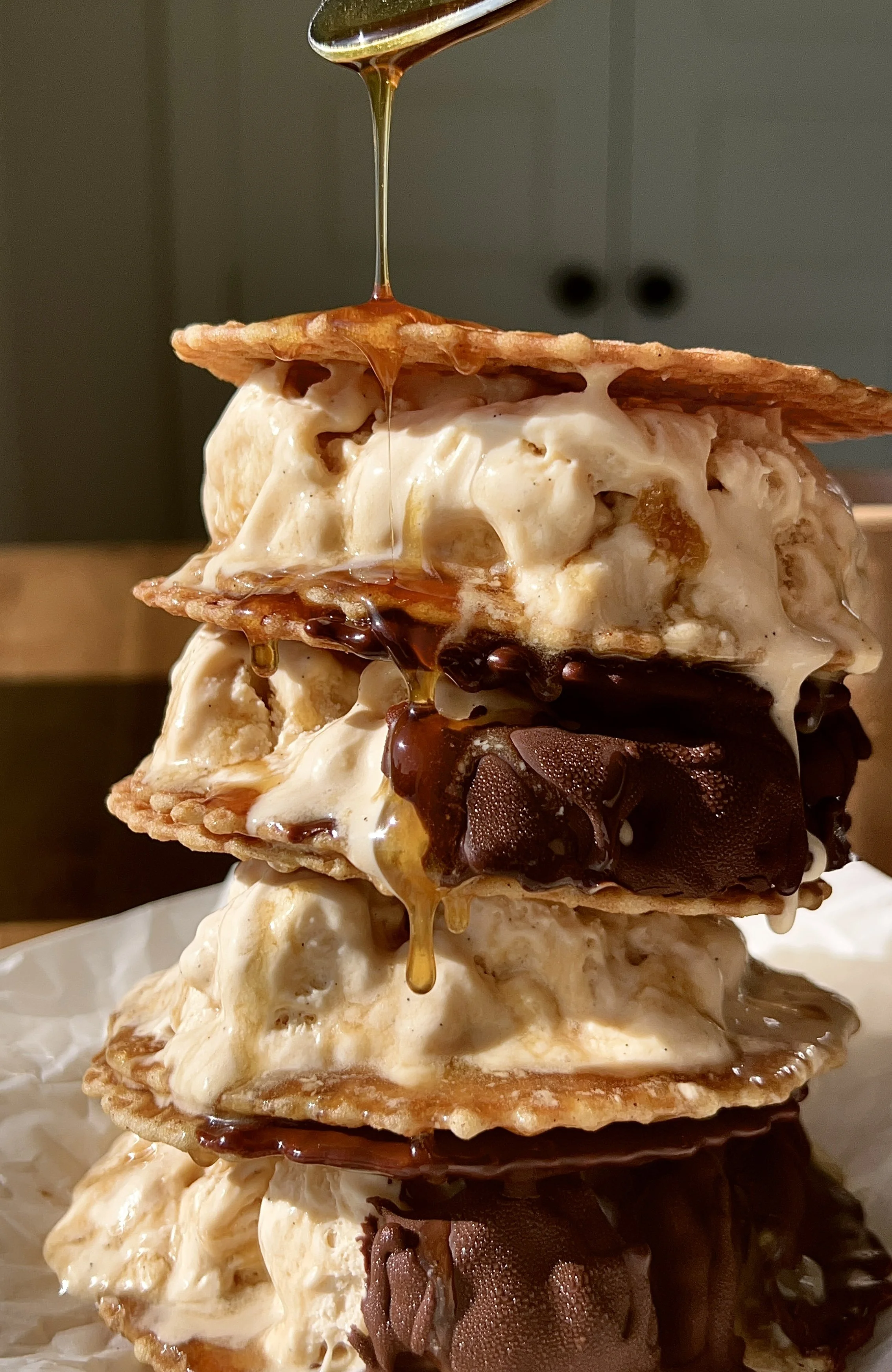 Salted maple swirl ice cream sandwiches with butter waffle cookies dipped in chocolate served as the ultimate summer frozen treat.