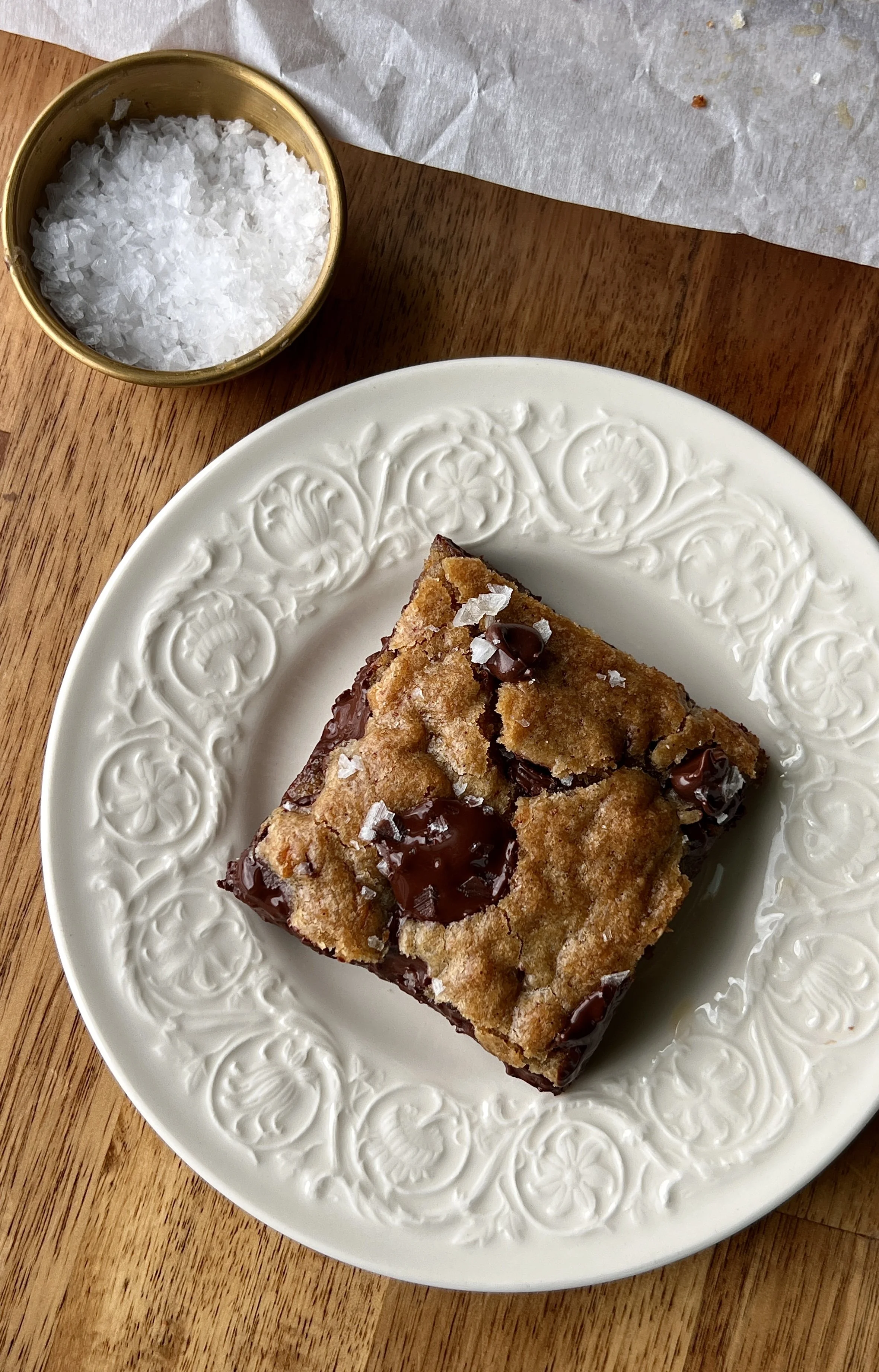 Close-up of a brown butter banana bread chocolate chip cookie bar showing the soft and gooey center with melty chocolate chips throughout and perfectly crisp and golden edges.