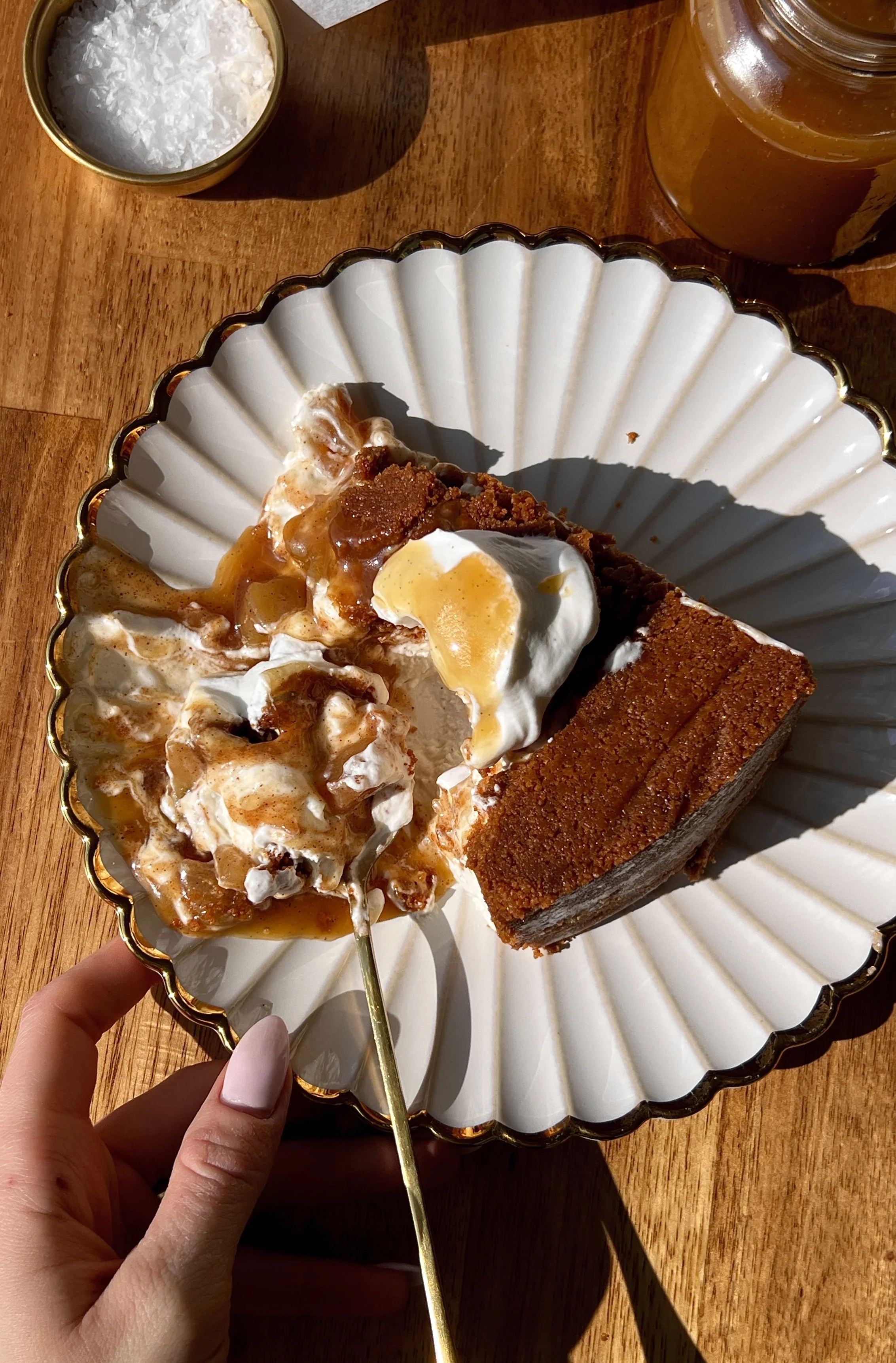 Upside down apple pie no-bake cheesecake with a buttery Biscoff cookie crust on top inverted to serve and finished with a brown sugar salted caramel drizzle as the ultimate fun and impressive fall no-bake dessert.
