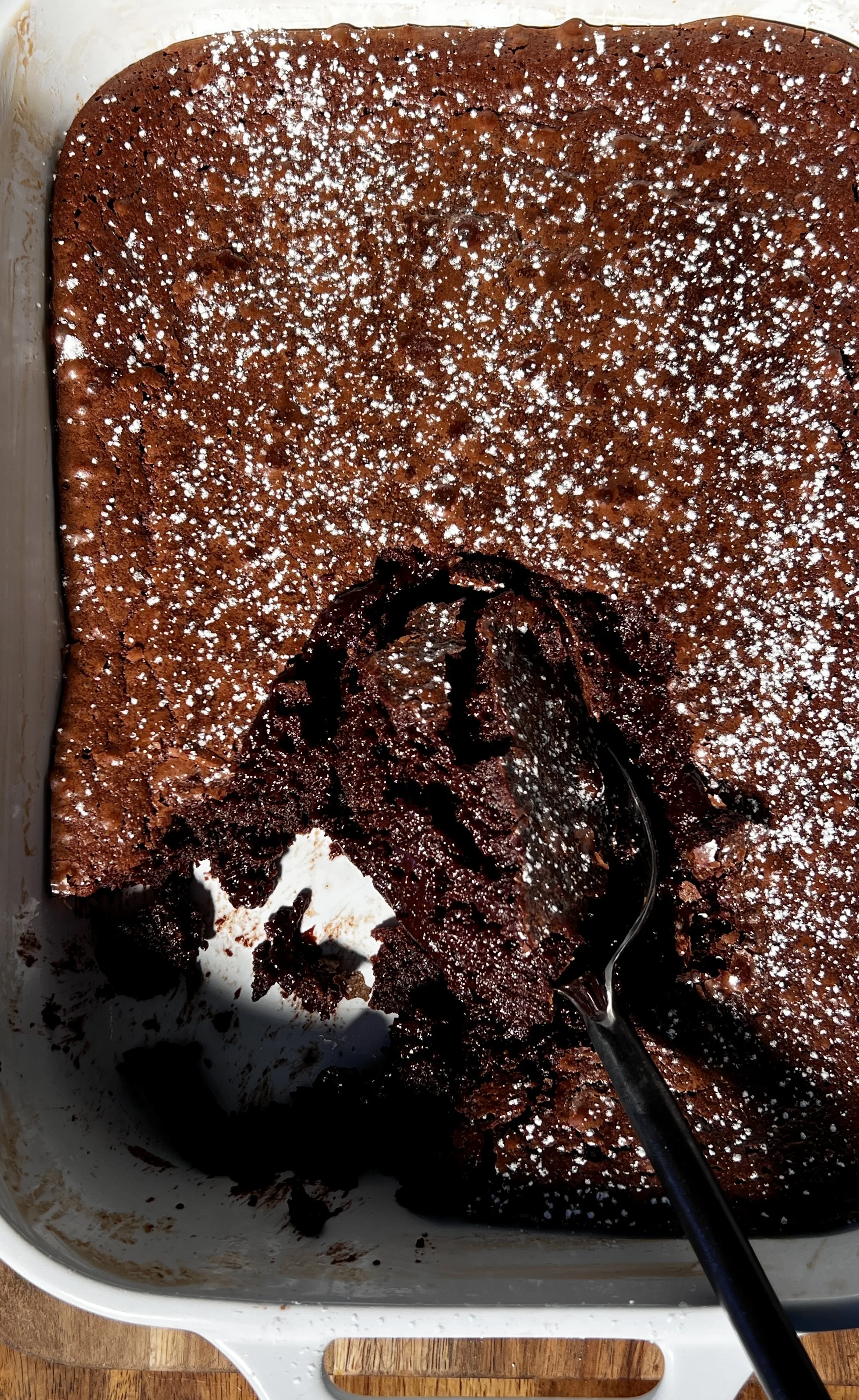 Warm deep dish brown butter molten lava cake with a gooey chocolate center, topped with vanilla ice cream and hot fudge.