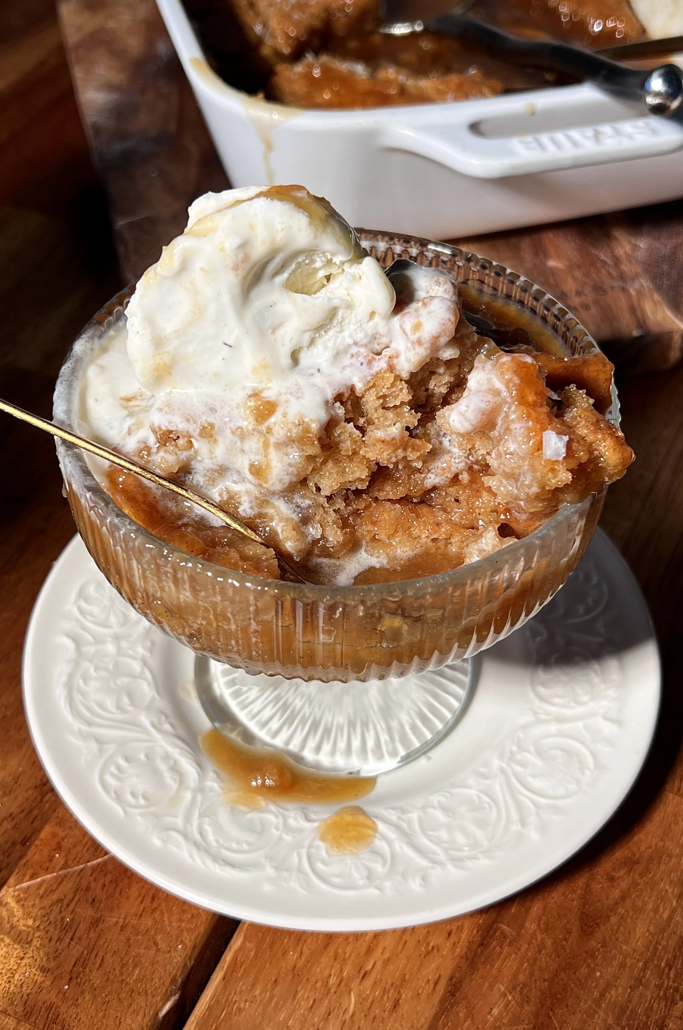Salted maple pudding cake baked until golden with a crisp top and gooey maple sauce underneath, finished with flaky sea salt and served warm with a scoop of vanilla ice cream.