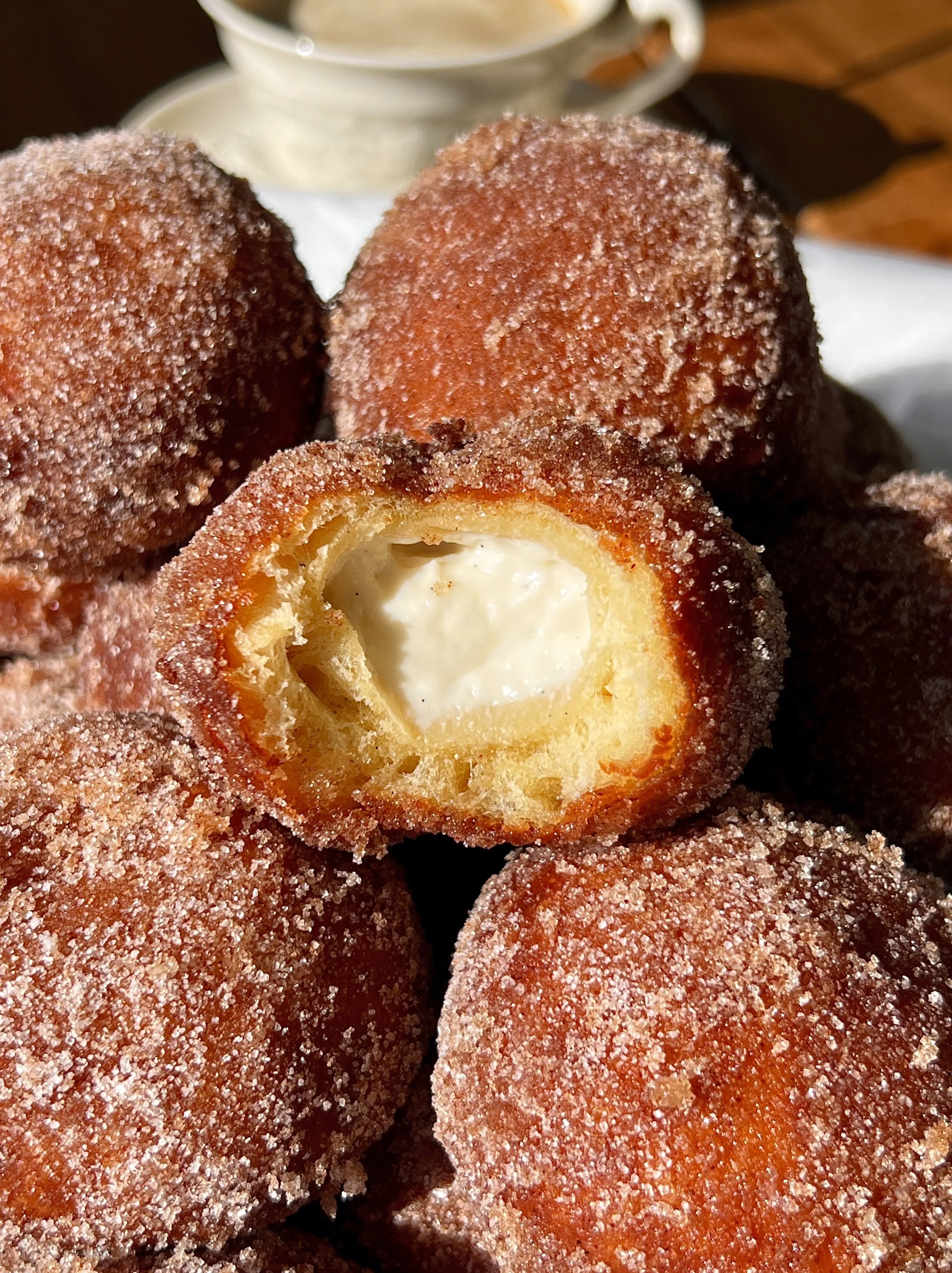 Apple cider cinnabon delights rolled in cinnamon sugar with a sweet tangy cream cheese filling and apple cider butter soak served warm.