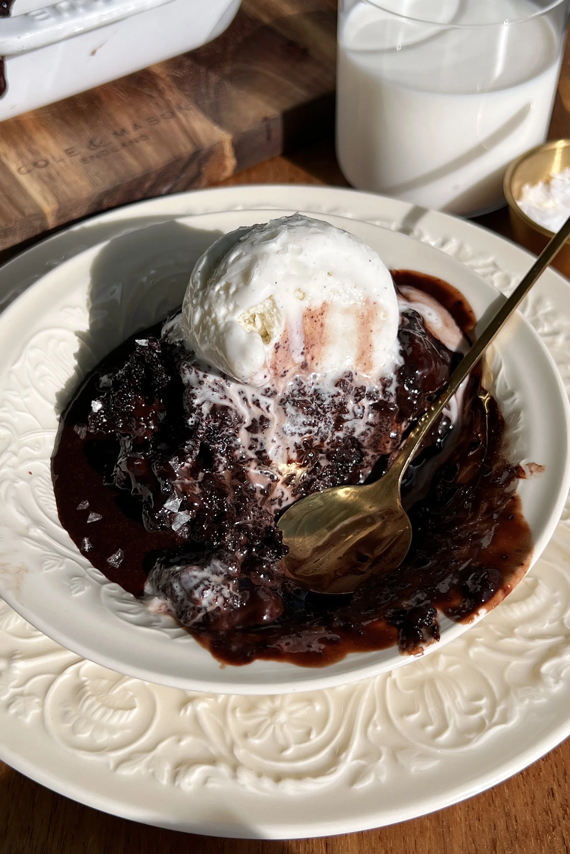 Warm hot chocolate fudge cake served with chocolate ganache, vanilla ice cream, and flaky sea salt.