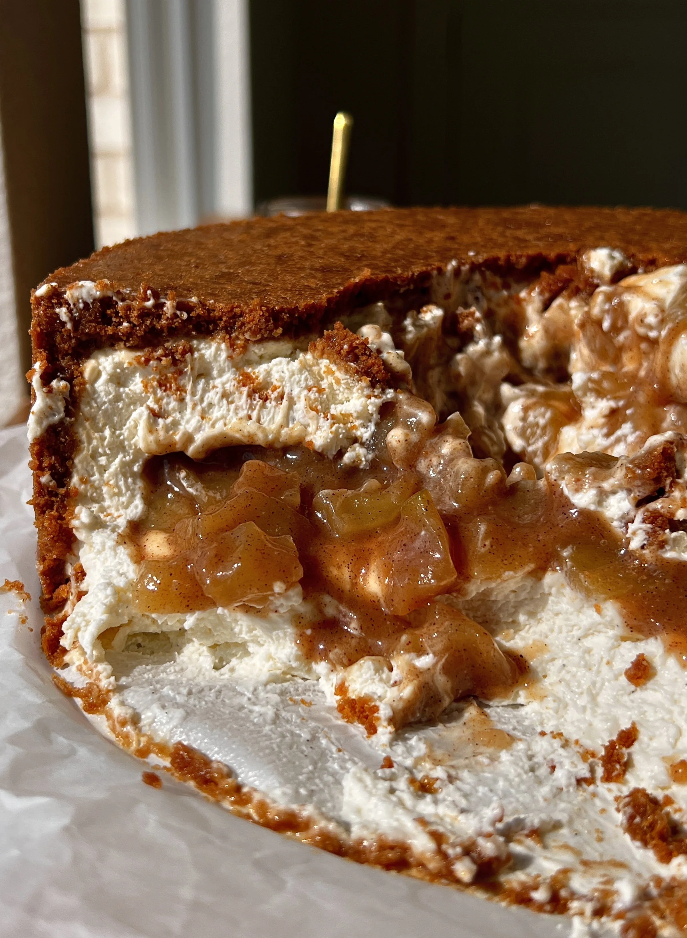 Close-up of an upside down apple pie no-bake cheesecake showing the rich and creamy cheesecake filling with a warm spiced homemade apple pie filling layer in the middle.