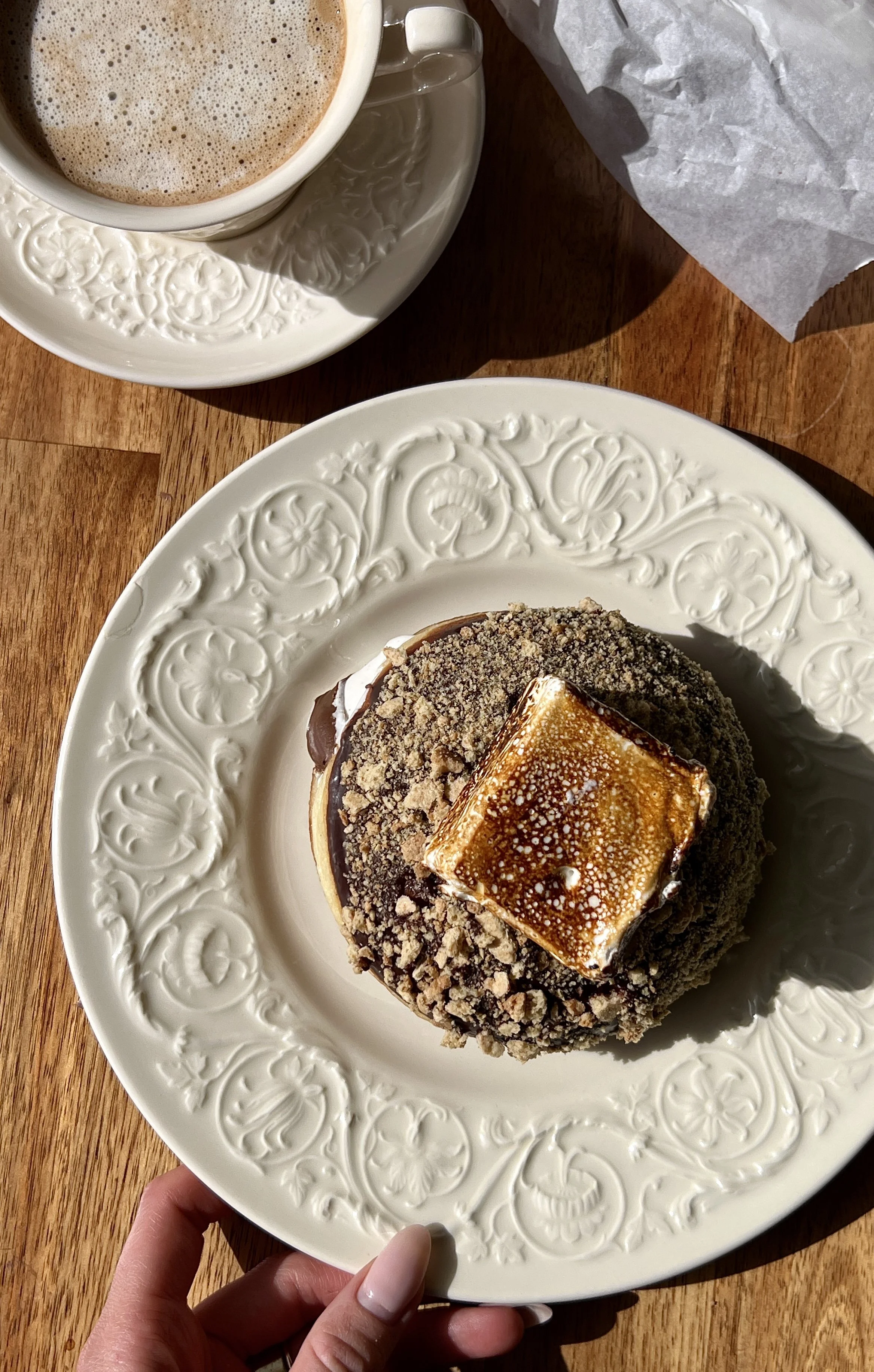 Pillowy soft and fluffy s'mores donuts with a beautifully golden exterior filled with marshmallow buttercream and Nutella finished with rich chocolate ganache, crushed graham crackers, and perfectly toasted marshmallows on top.
