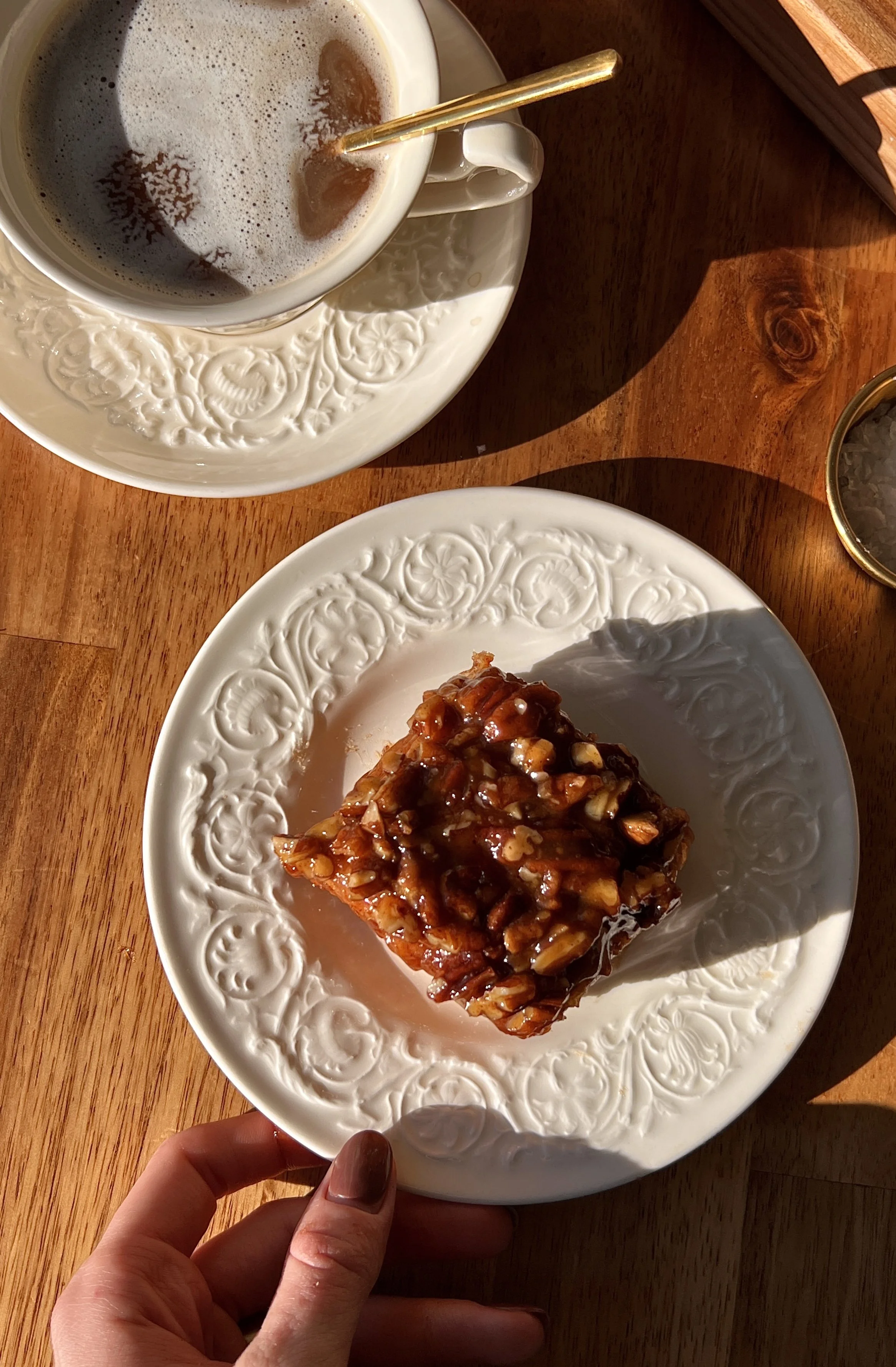 Pillowy soft and fluffy sweet potato sticky rolls with a warm spiced sweet potato interior and gooey caramelized sticky pecan topping served warm with a steaming hot cup of coffee as the ultimate cozy fall breakfast.
