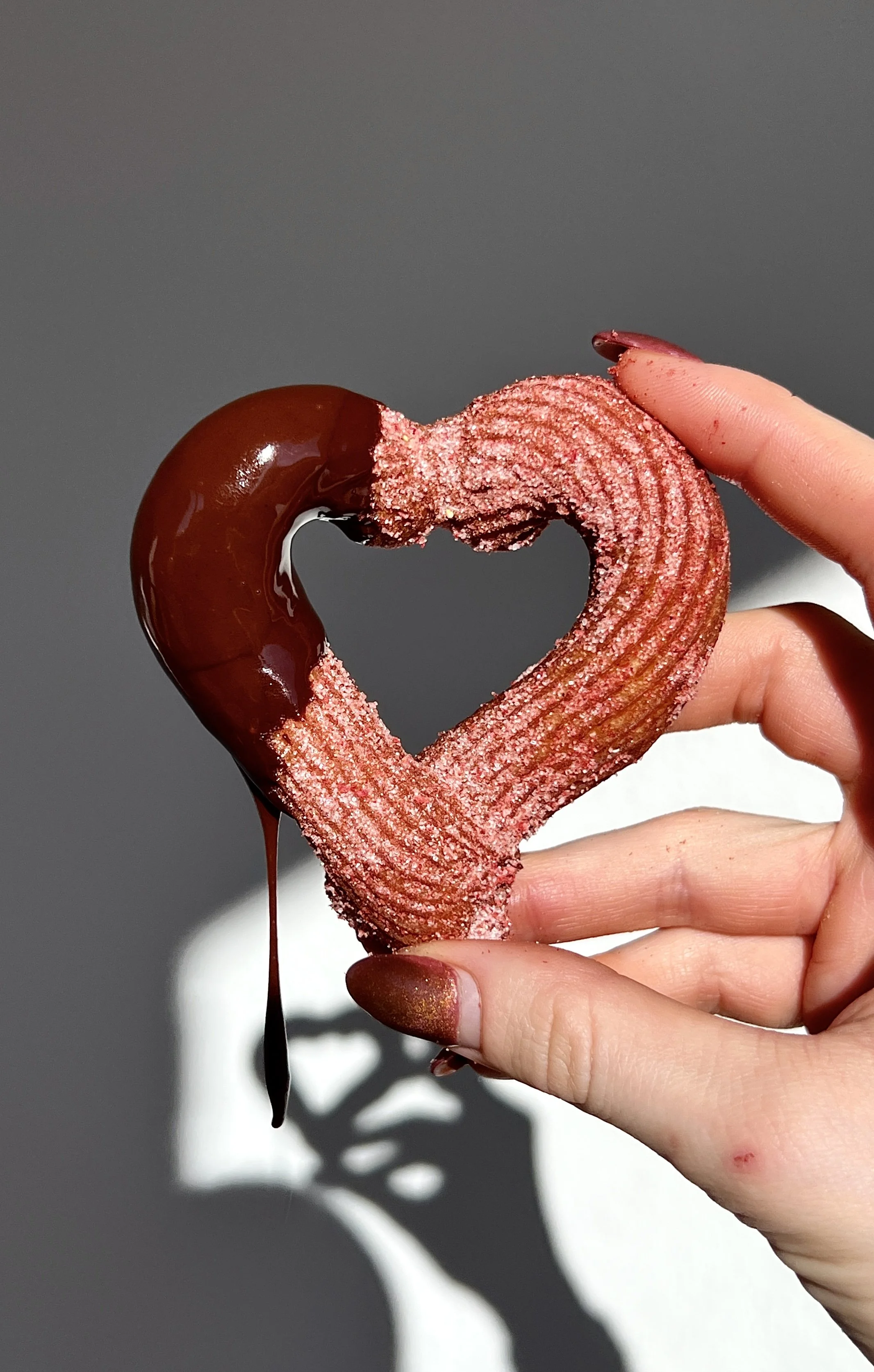 Warm heart churros for Valentine’s Day served with a rich homemade chocolate dipping sauce.