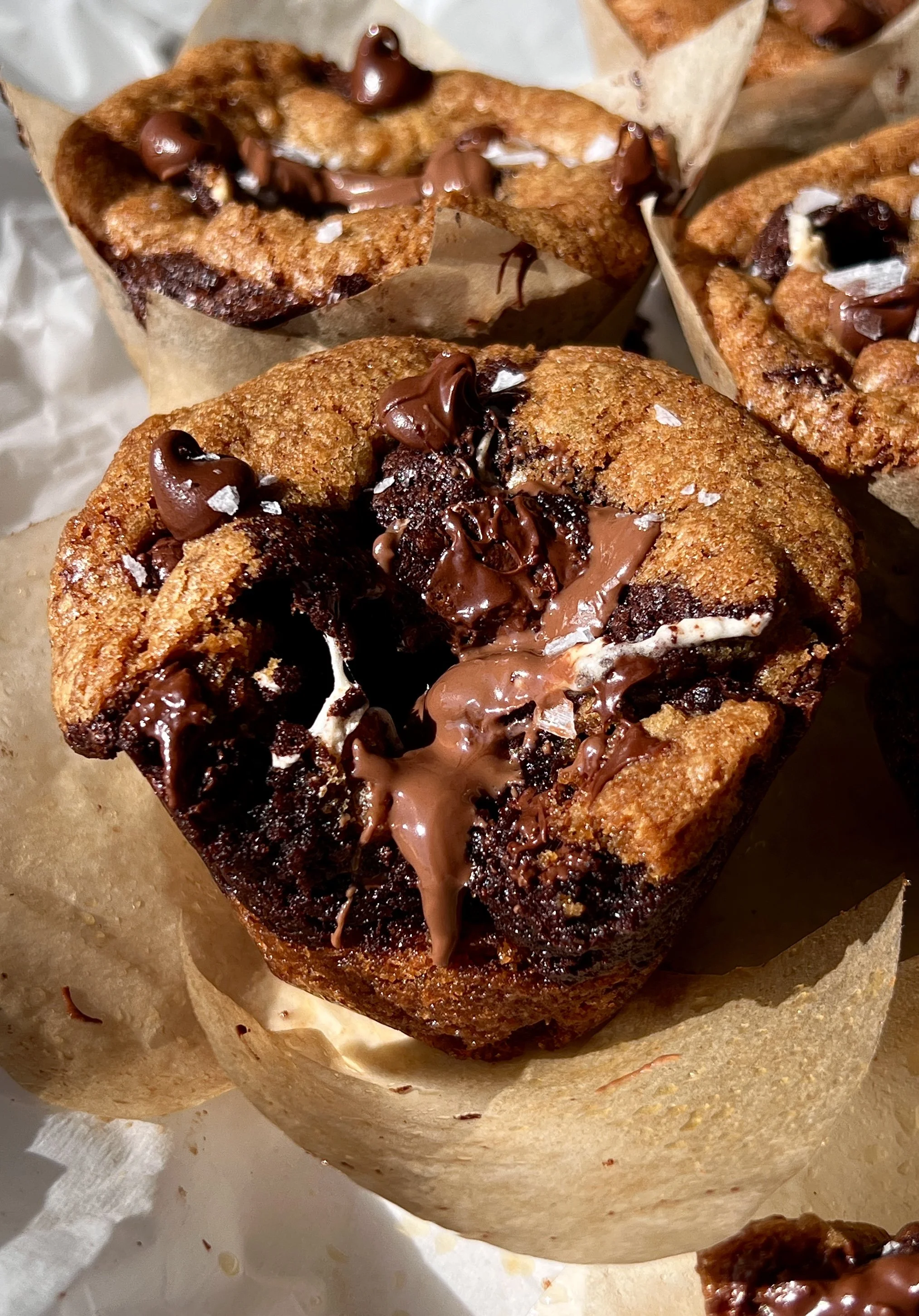 Brown butter s'mores brookie cups with graham cracker, gooey marshmallow, and melty milk chocolate served warm with a sprinkle of flaky sea salt and a cold glass of milk.