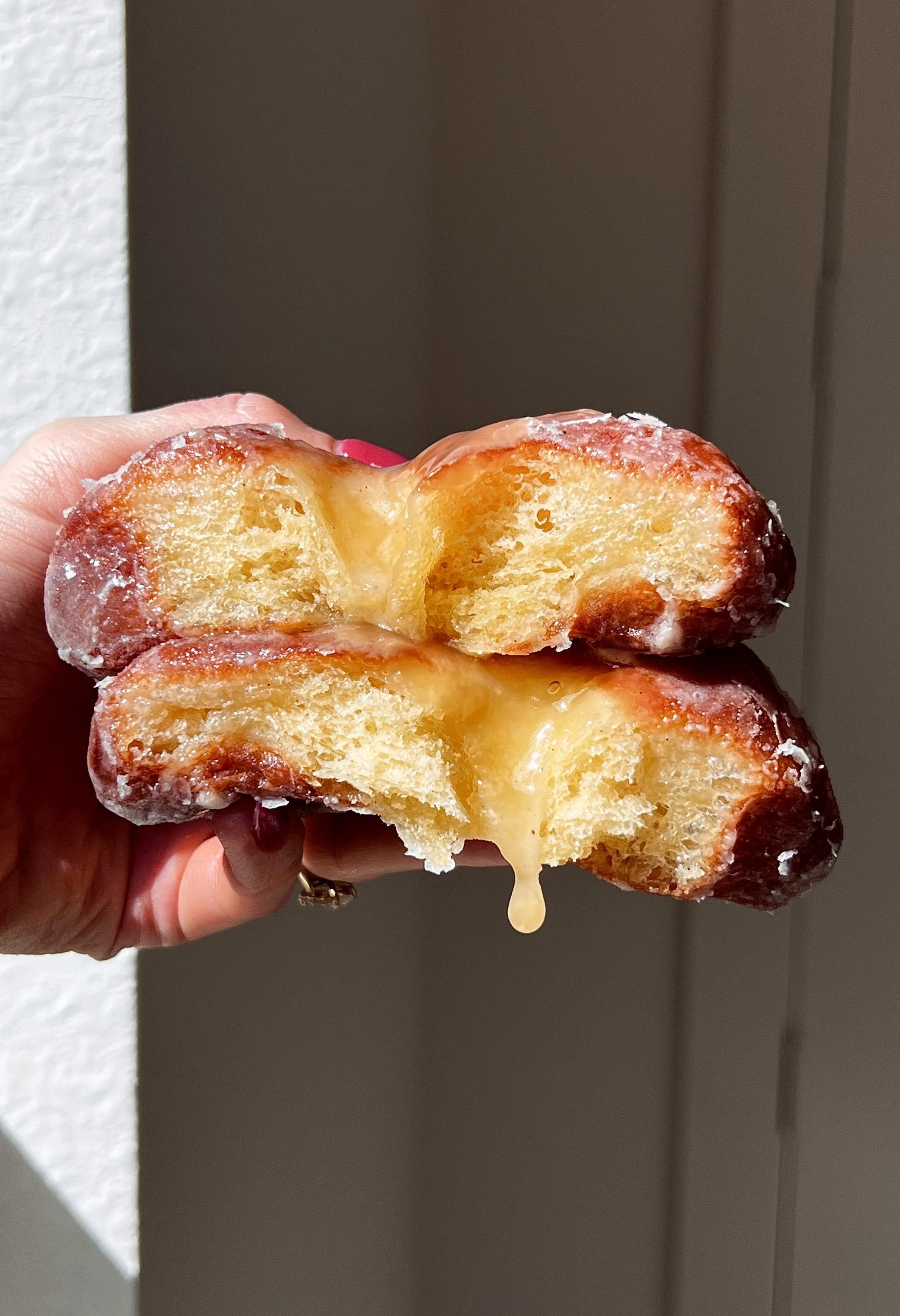 Flower donut filled with fruit preserves or lemon curd with glossy vanilla glaze.
