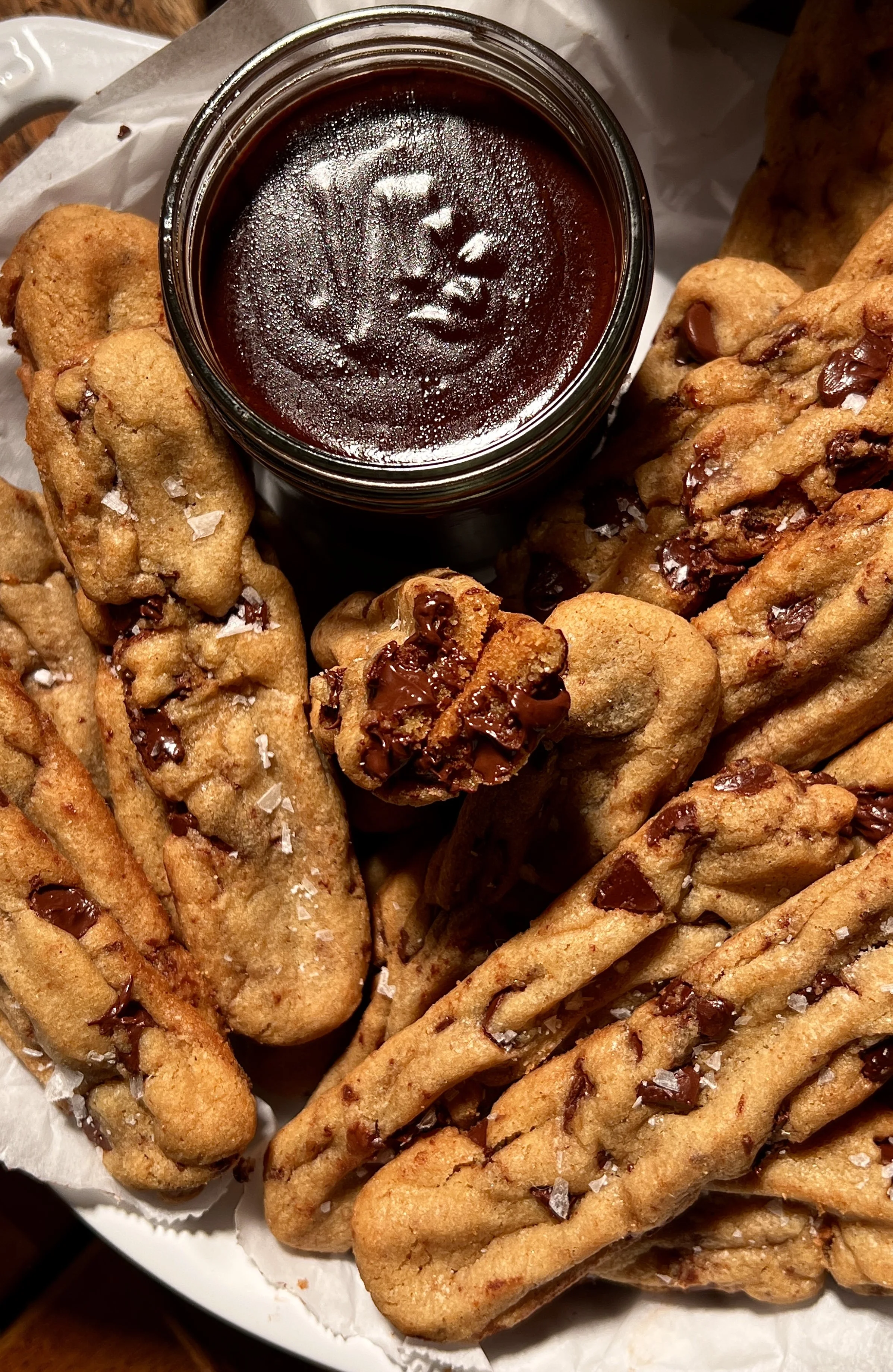 Brown butter chocolate chip cookie fries with crisp edges and melty chocolate chips, served warm with hot fudge sauce and flaky sea salt.