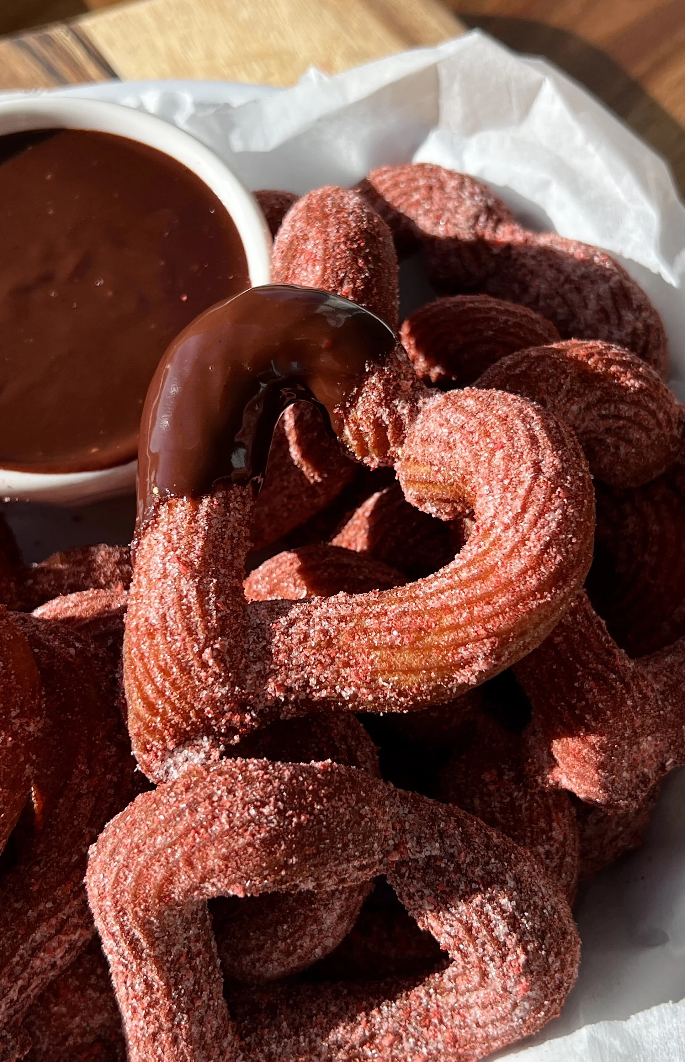 Warm heart churros for Valentine’s Day served with a rich homemade chocolate dipping sauce.