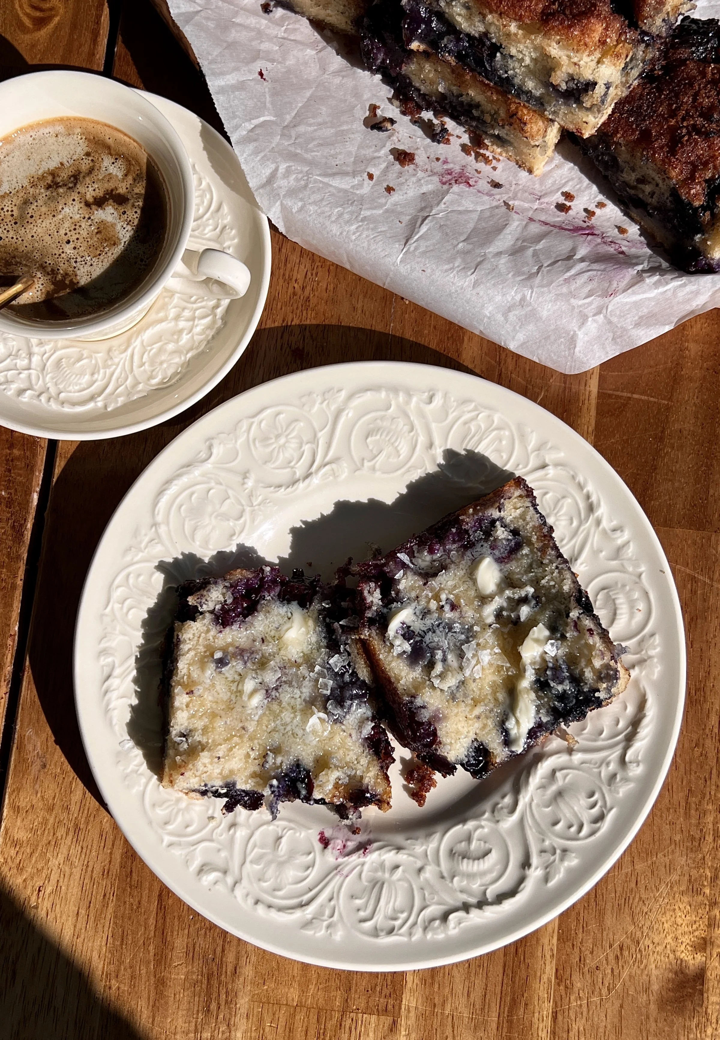 Warm cinnamon crunch blueberry butter swim biscuits served with butter, flaky sea salt, and coffee.