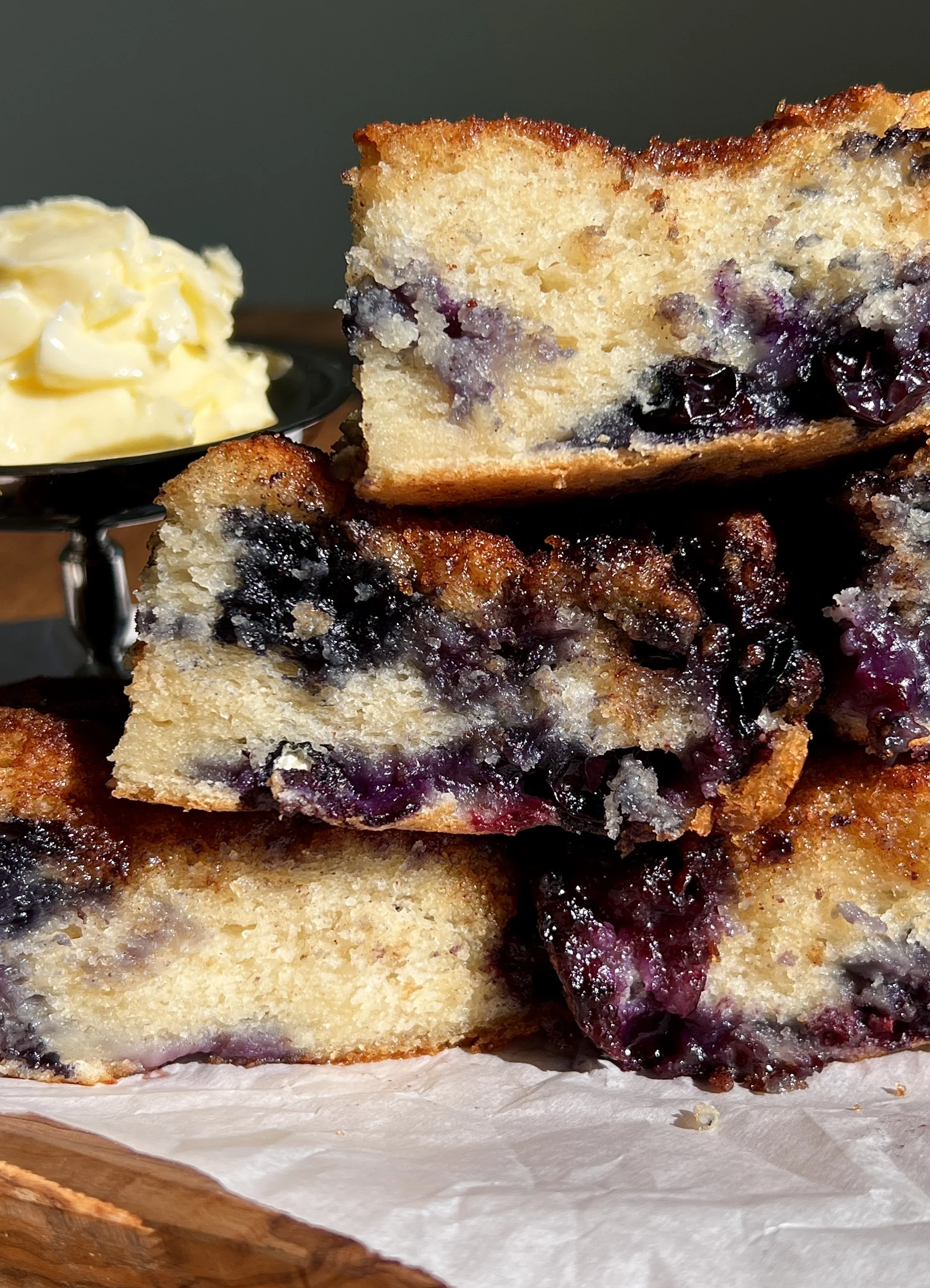 Close-up of cinnamon crunch blueberry butter swim biscuits showing juicy blueberries and buttery crumb.