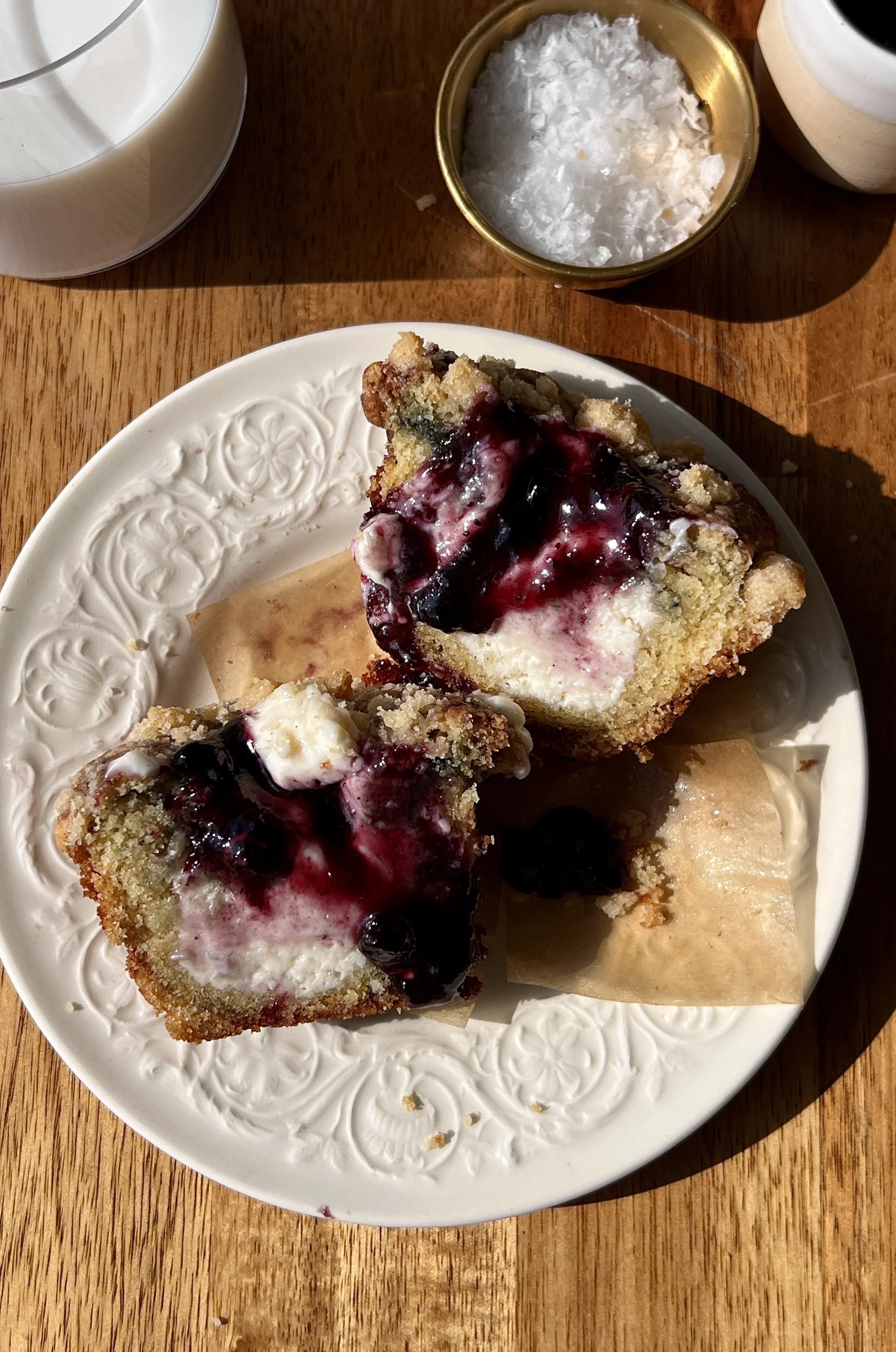 Soft and buttery blueberry muffin cheesecake cookie cups filled with rich and creamy cheesecake filling and bright blueberry flavor finished with a perfectly golden crumble topping served warm with a cold glass of milk.