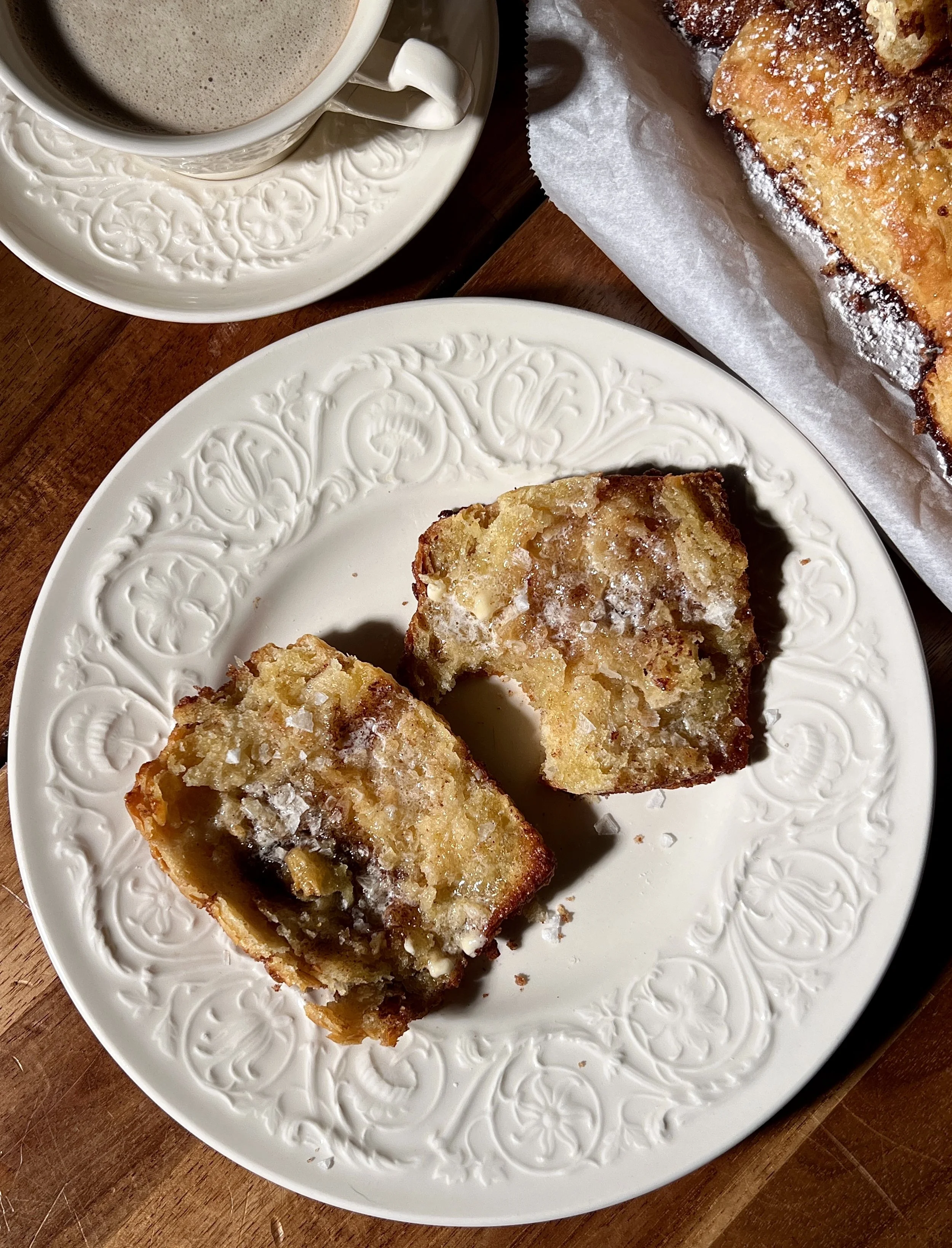 Close-up of flaky French toast biscuits showing buttery layers and cinnamon sugar swirls.