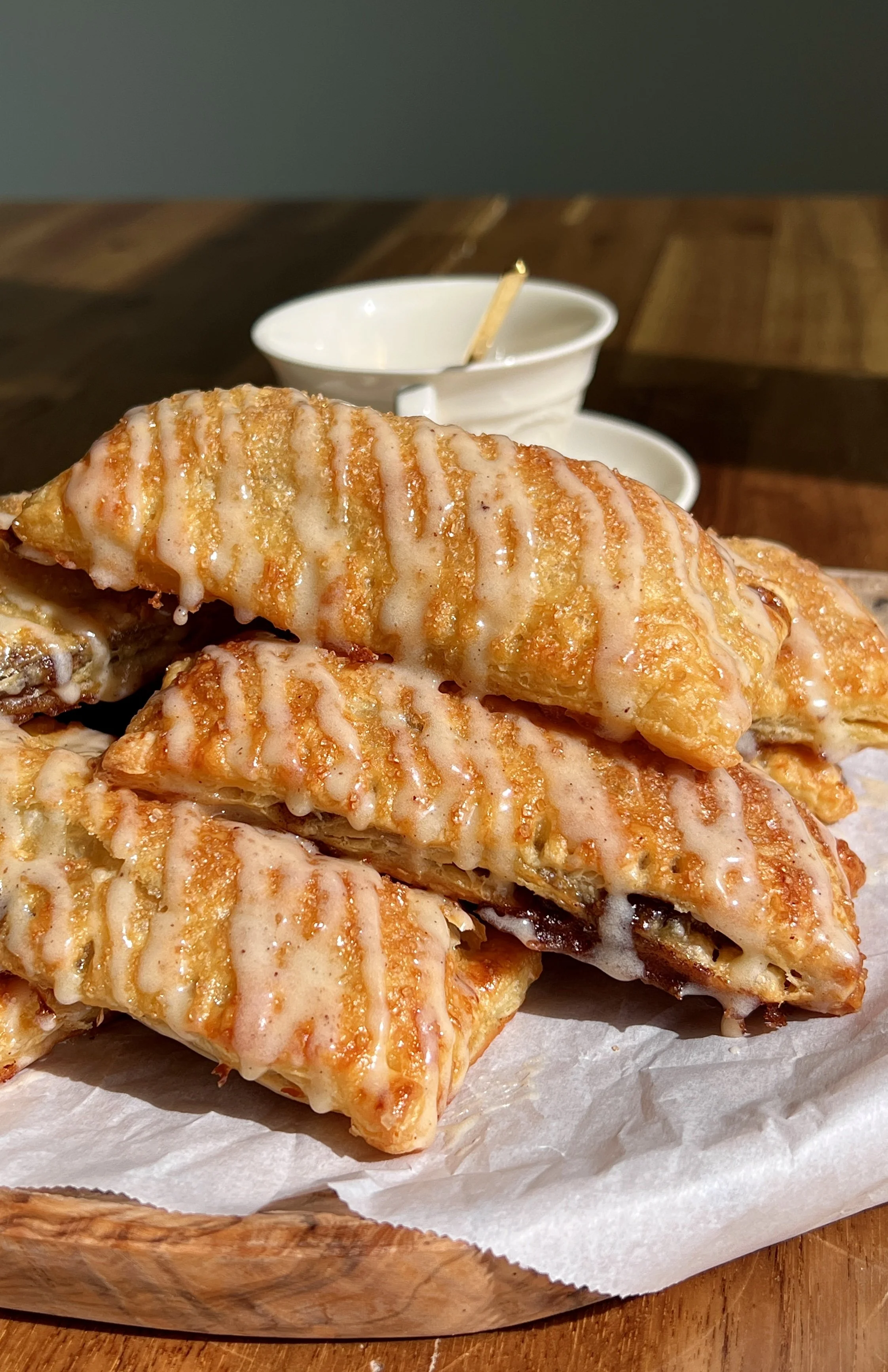 Homemade cinnamon roll toaster strudels made with flaky puff pastry and topped with brown butter maple cream cheese glaze.