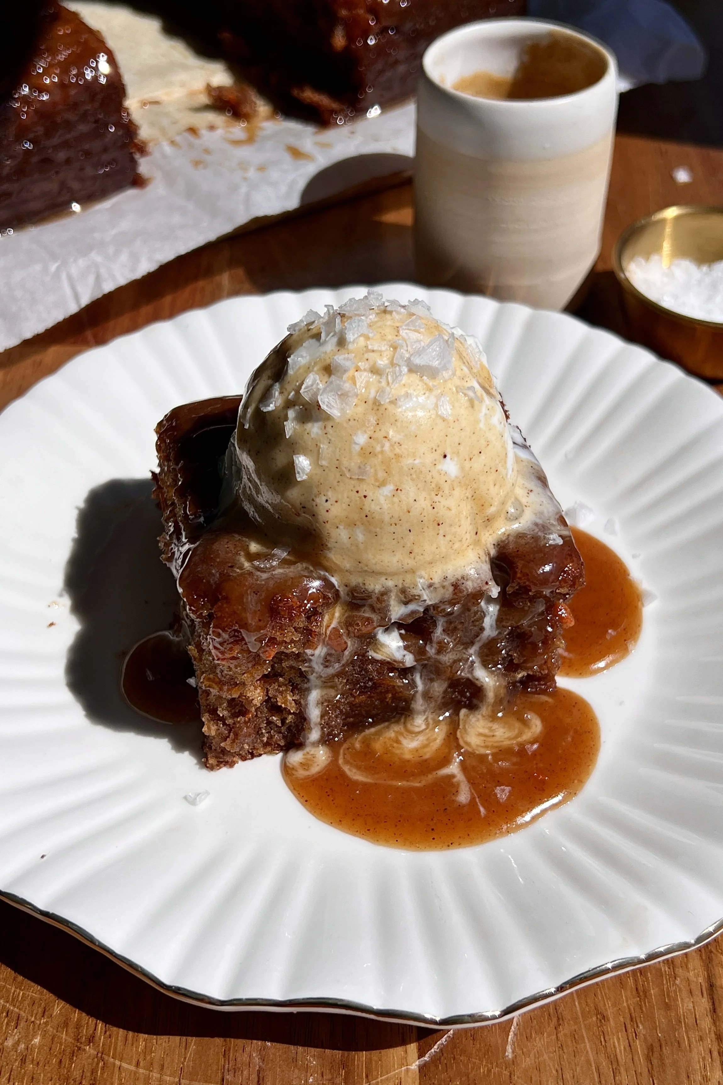Warm carrot cake sticky toffee pudding served with spiced toffee sauce, vanilla ice cream, and flaky sea salt.