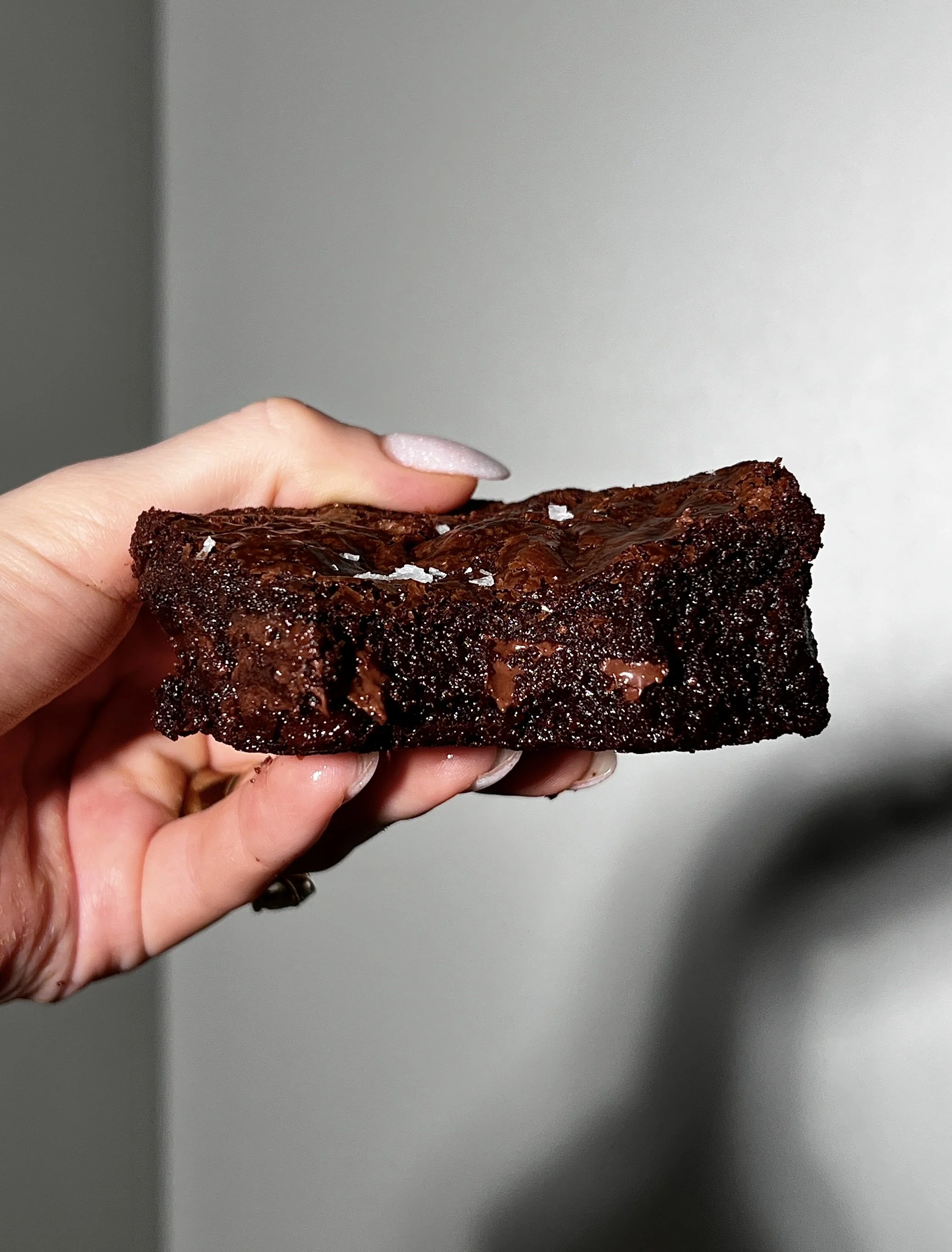 Rich fudgy brown butter brownies with a crinkle top, chocolate chips throughout, and a sprinkle of flaky sea salt.
