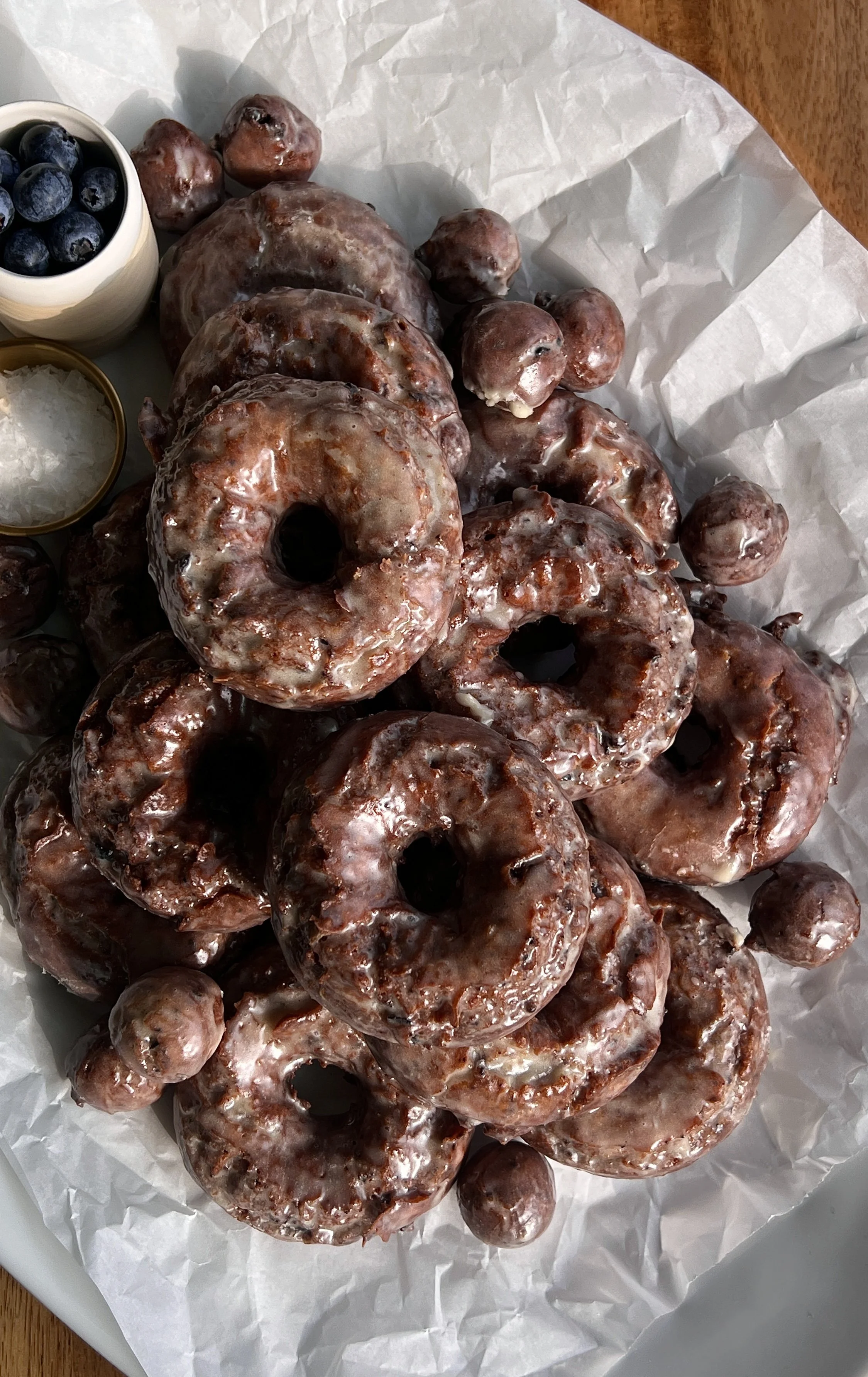 Old-fashioned blueberry cake donuts with vanilla bean glaze and signature cracked tops.