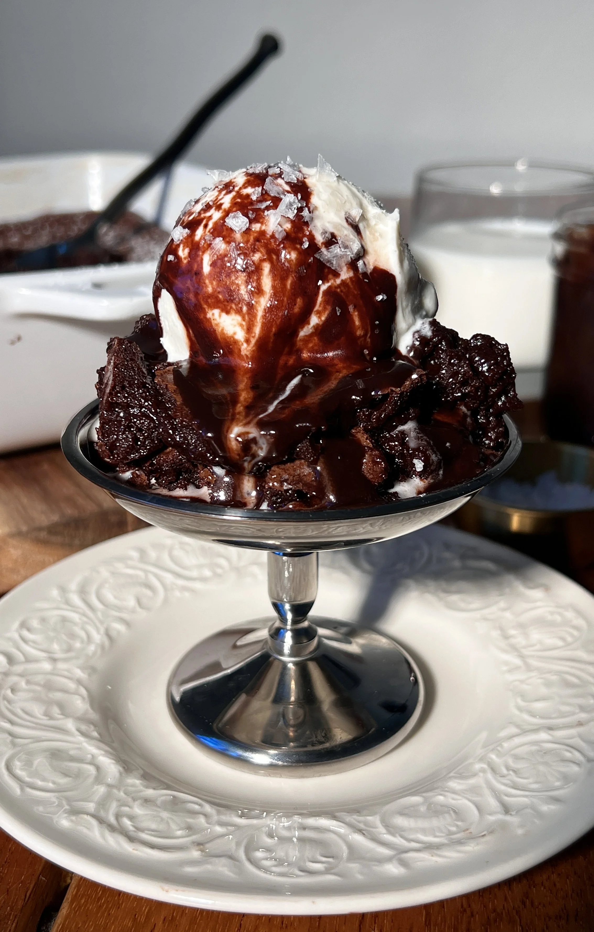 Warm deep dish brown butter molten lava cake with a gooey chocolate center, topped with vanilla ice cream and hot fudge.