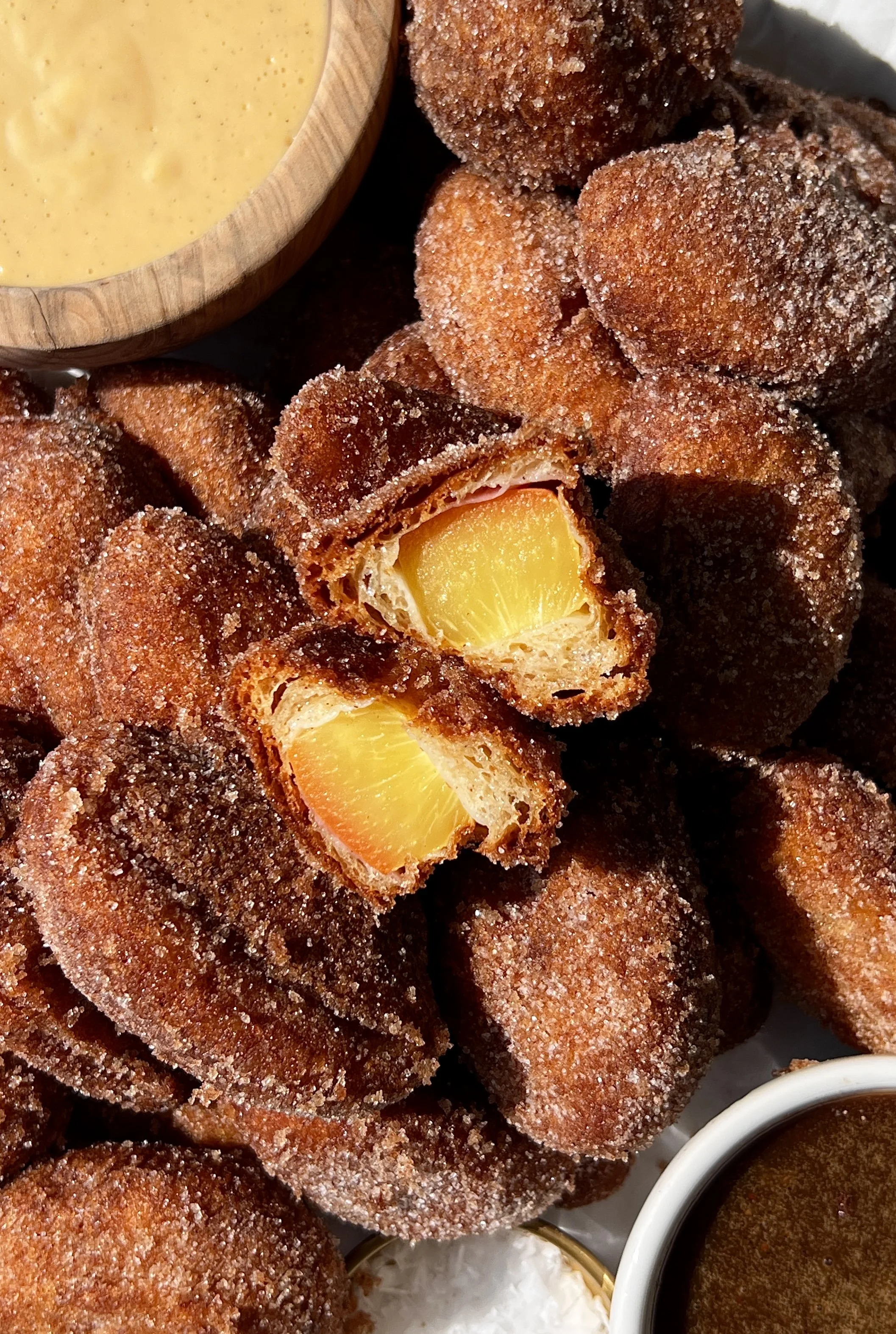 Buttermilk fried peaches rolled in cinnamon sugar served with homemade crème anglaise and easy salted caramel as the ultimate summer dessert.