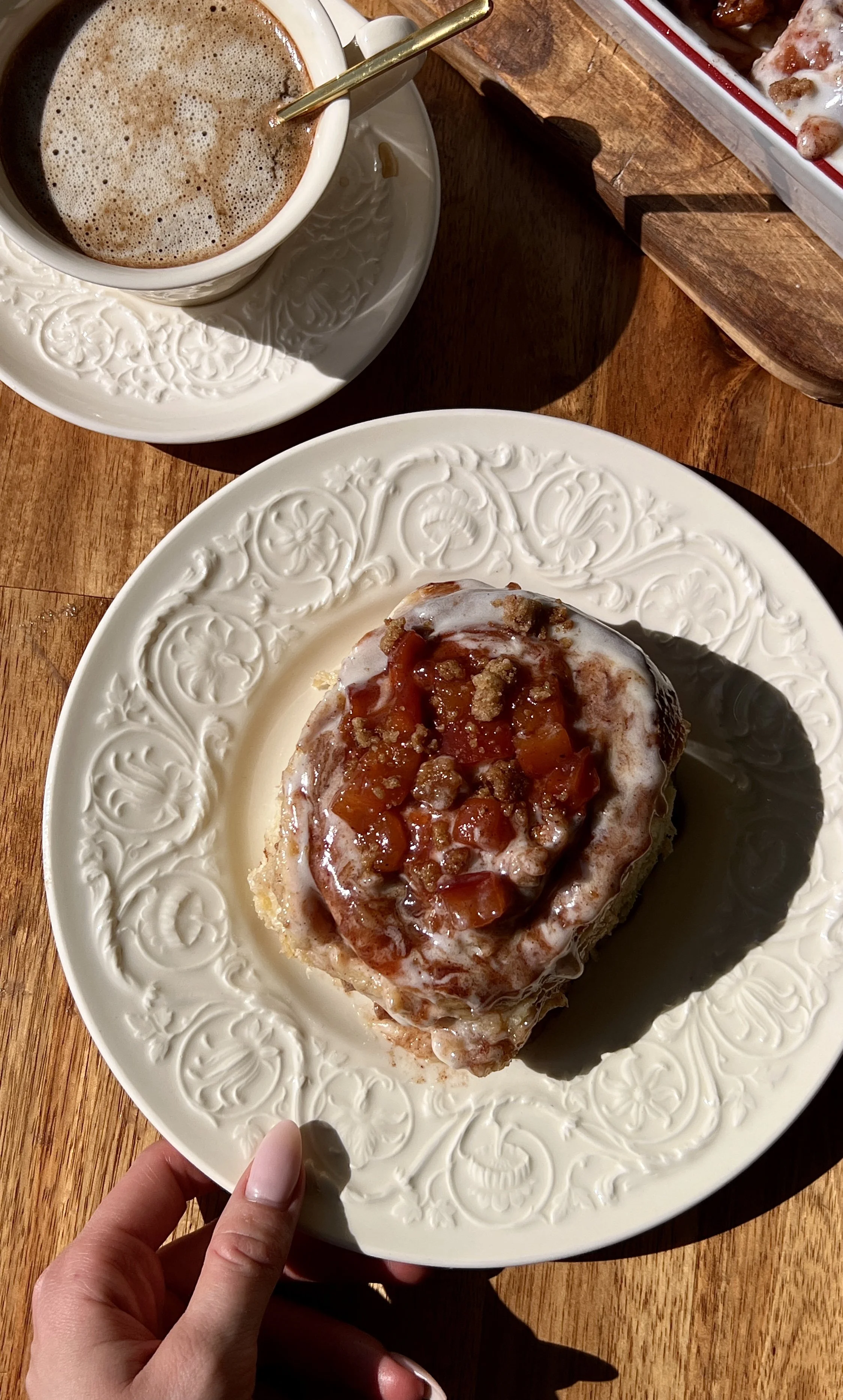 Pillowy soft and fluffy peach cobbler cinnamon rolls with gooey brown sugar cinnamon swirls and warm spiced homemade peach compote finished with smooth cream cheese frosting served warm with a hot cup of coffee.