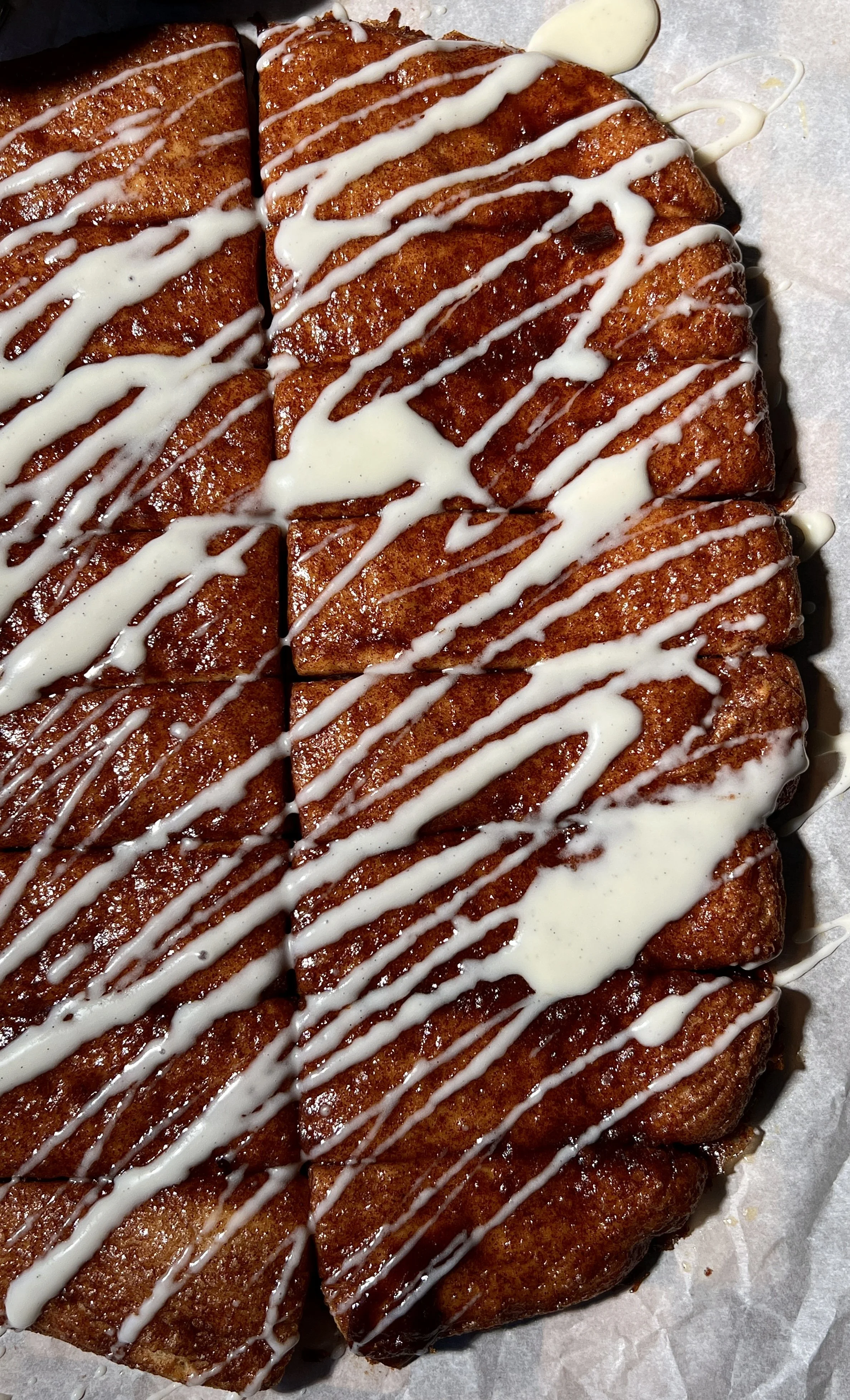 Soft and fluffy sourdough cinnasticks made with sourdough discard and Greek yogurt dough, topped with gooey cinnamon sugar and drizzled with a tangy cream cheese glaze, served warm.