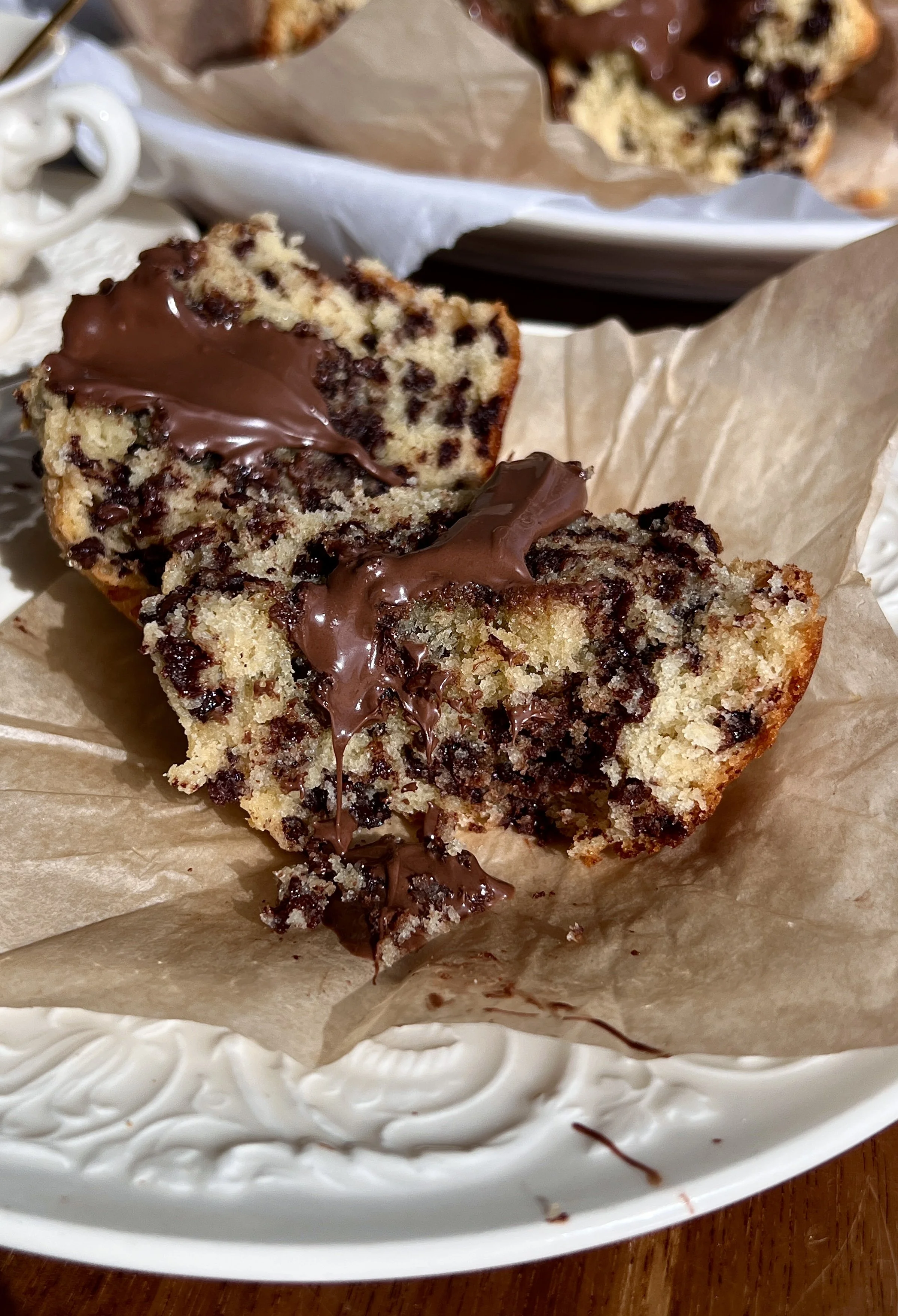 Warm bakery-style Nutella chocolate chip muffins served with a hot cup of coffee.