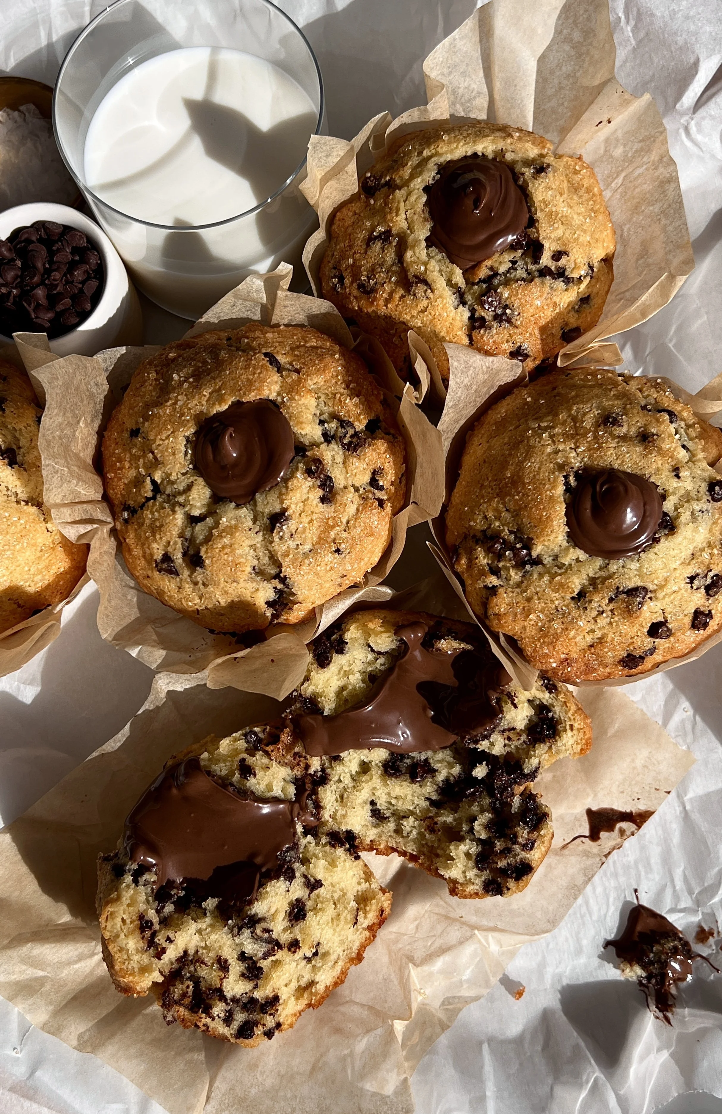 Bakery-style Nutella chocolate chip muffins with golden domed tops and gooey Nutella centers.
