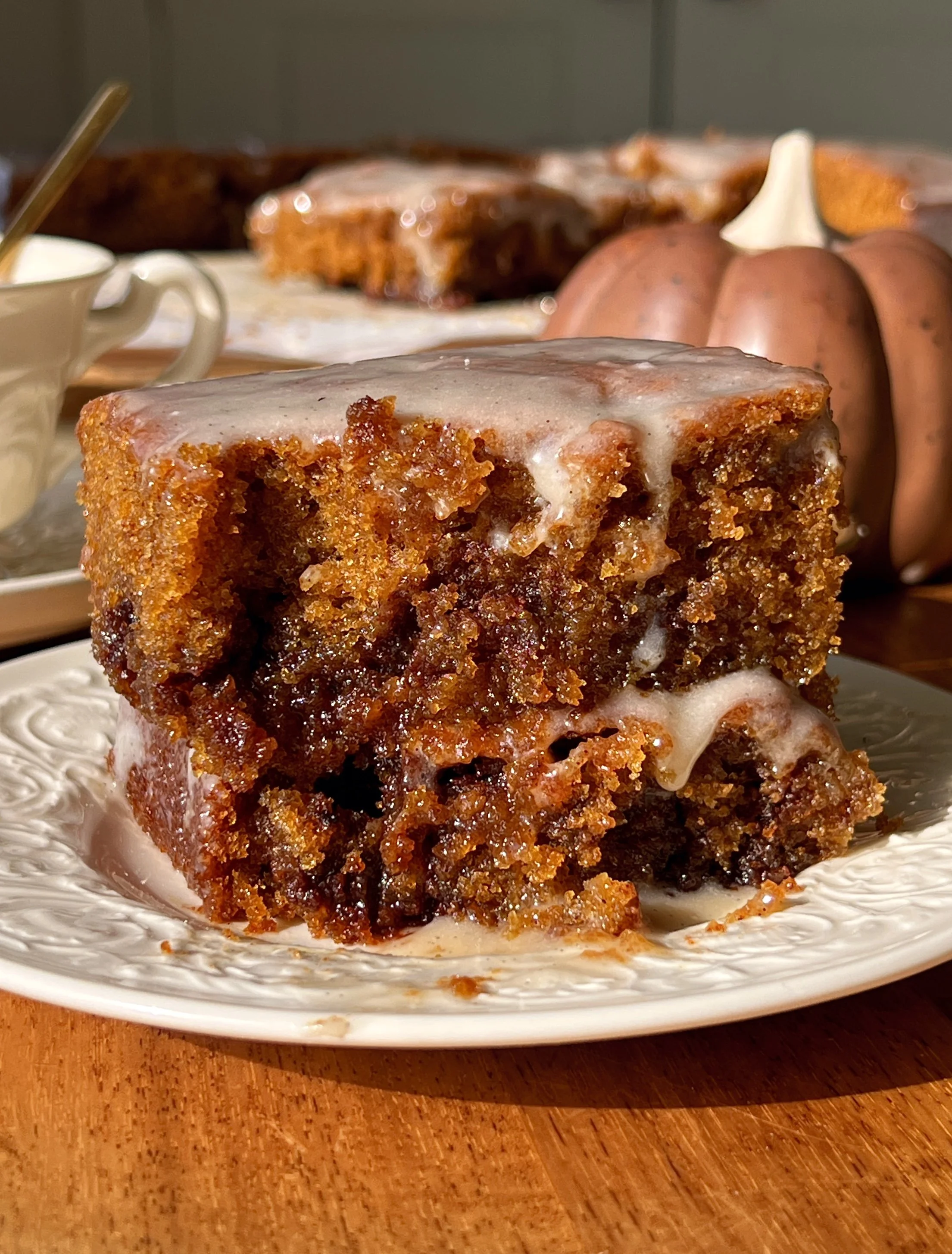 Warm and cozy pumpkin honey bun cake with a soft tender spiced pumpkin crumb and cinnamon brown sugar swirl throughout finished with a honey cream cheese glaze blanket as the ultimate cozy fall dessert.
