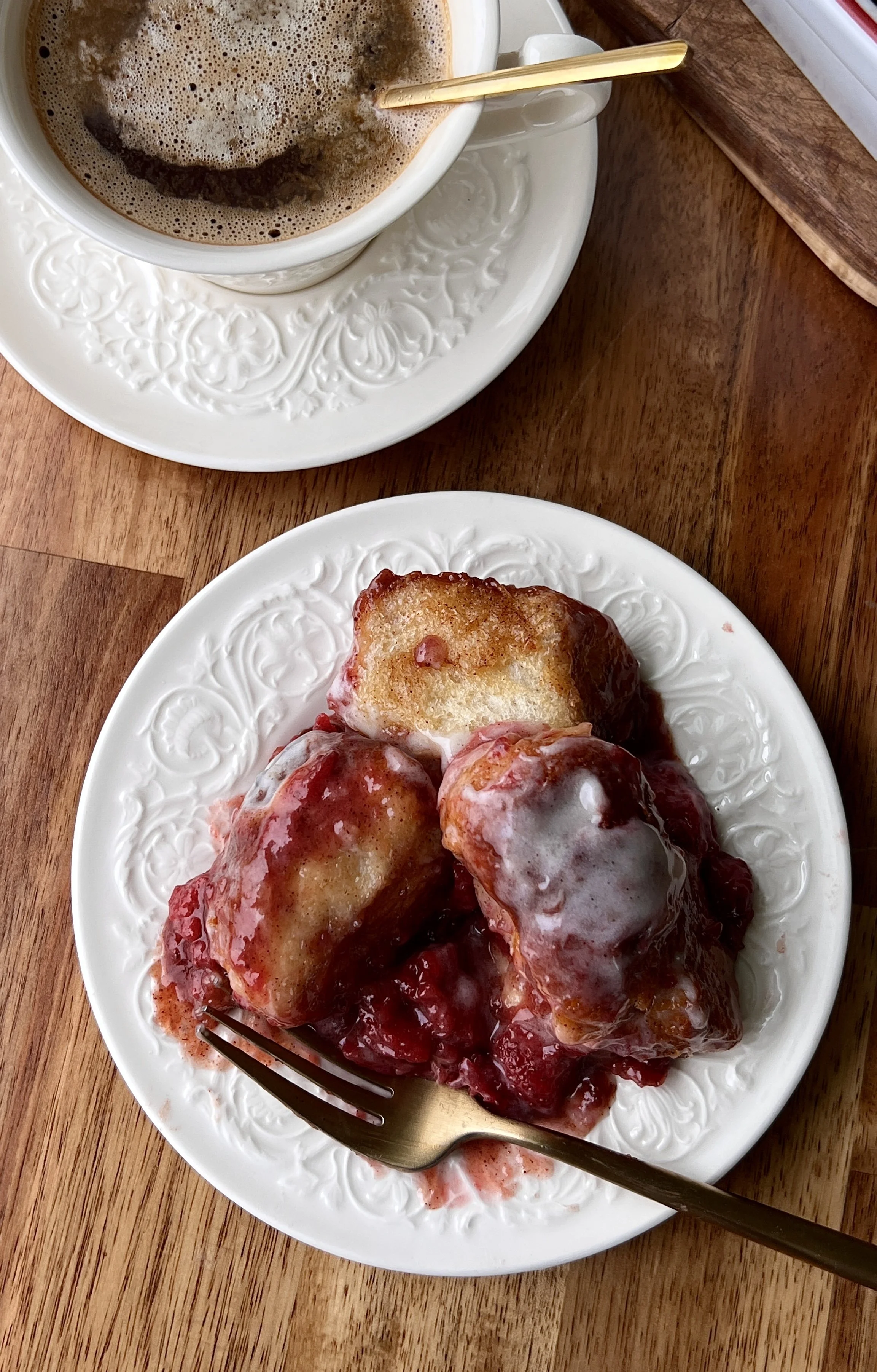 Soft, fluffy, and perfectly gooey strawberry cinnamon roll bites layered with homemade strawberry compote and brown sugar syrup finished with a tangy cream cheese glaze served warm with a hot cup of coffee.
