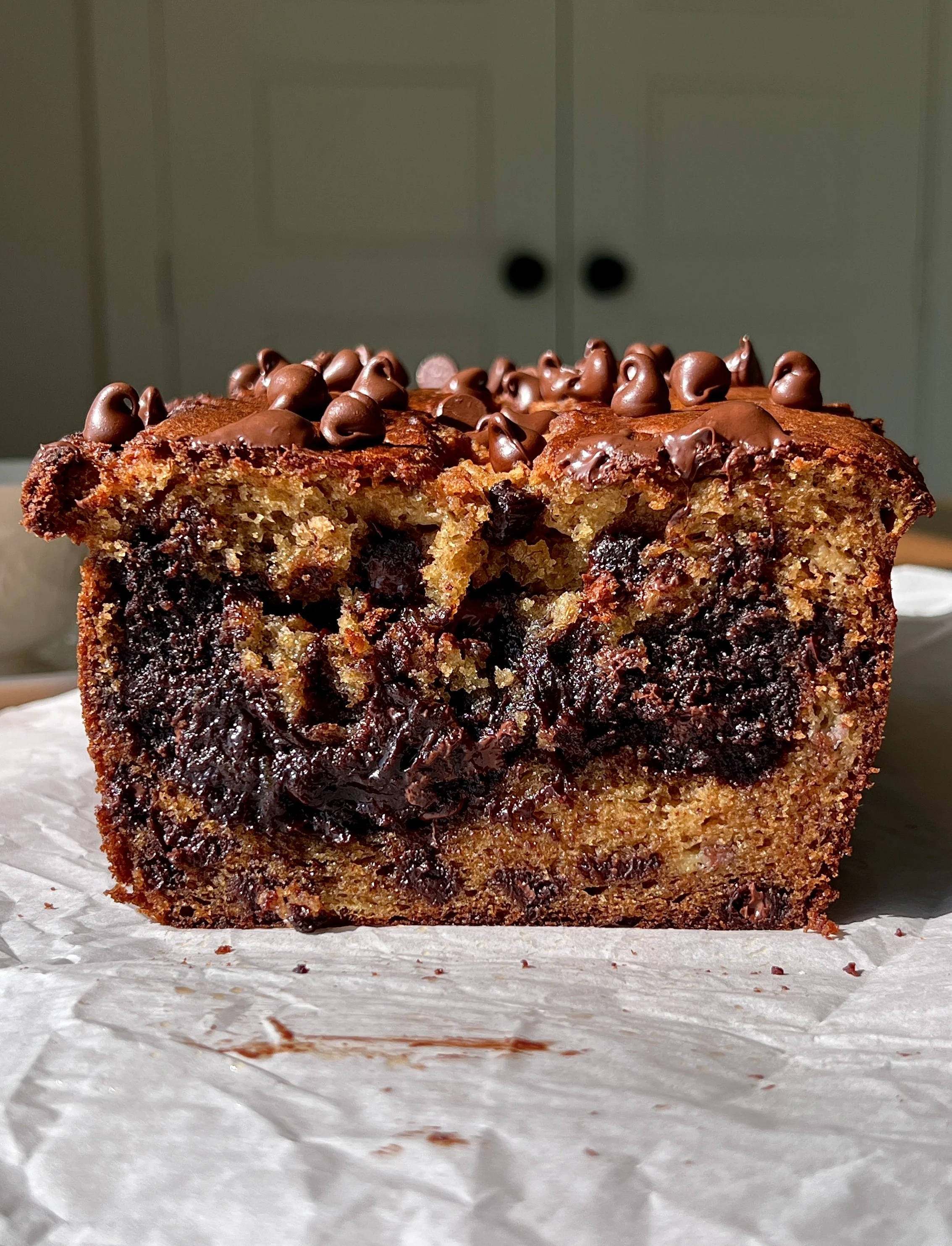 Close-up of a slice of brownie stuffed banana bread showing the soft fluffy banana bread exterior and rich fudgy brownie filling melting throughout.