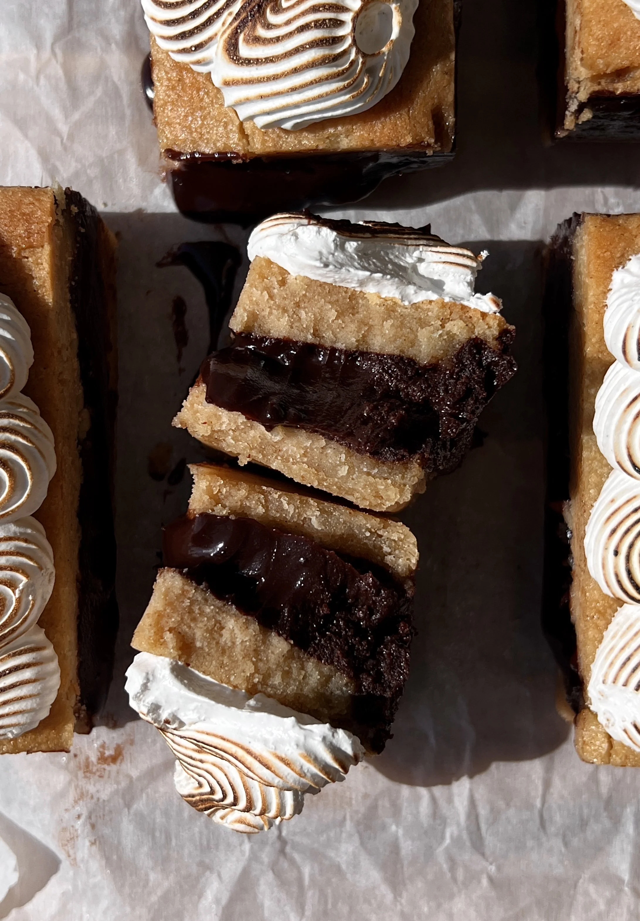 Close-up of a s'mores fudge shortbread bar showing the soft buttery graham cracker shortbread base, rich decadent fudge layer, and perfectly toasted marshmallow creme on top.