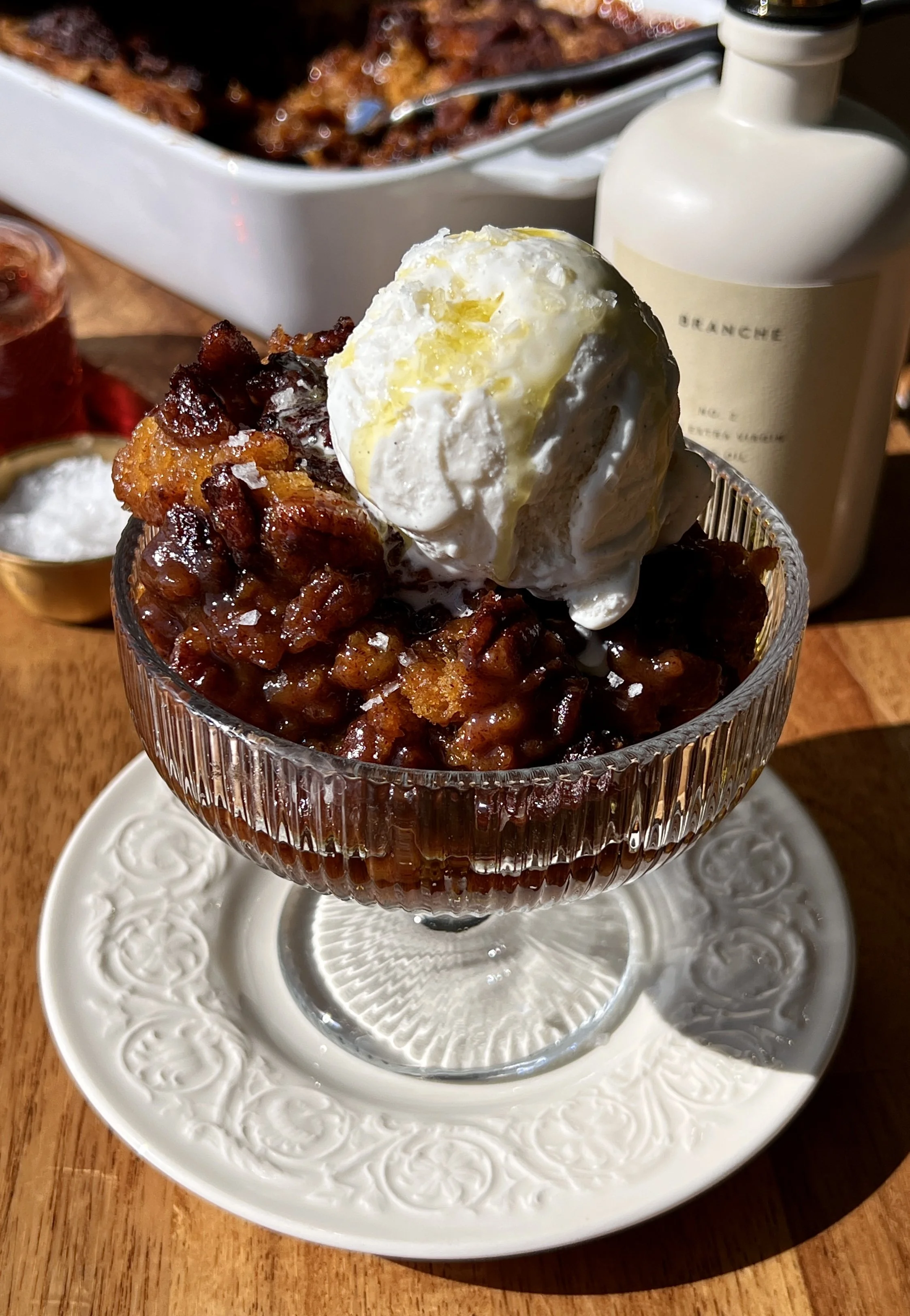 Brown butter sweet potato pecan pudding cake with a golden crisp top and gooey syrupy bottom served warm with a scoop of vanilla ice cream and flaky sea salt.