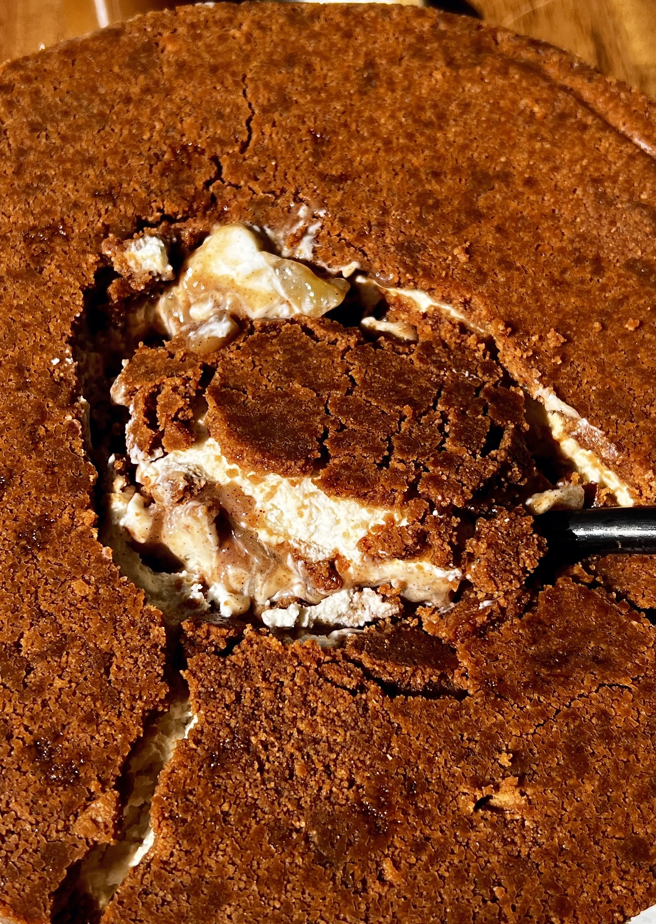 Close-up of an upside down apple pie no-bake cheesecake showing the rich and creamy cheesecake filling with a warm spiced homemade apple pie filling layer in the middle.