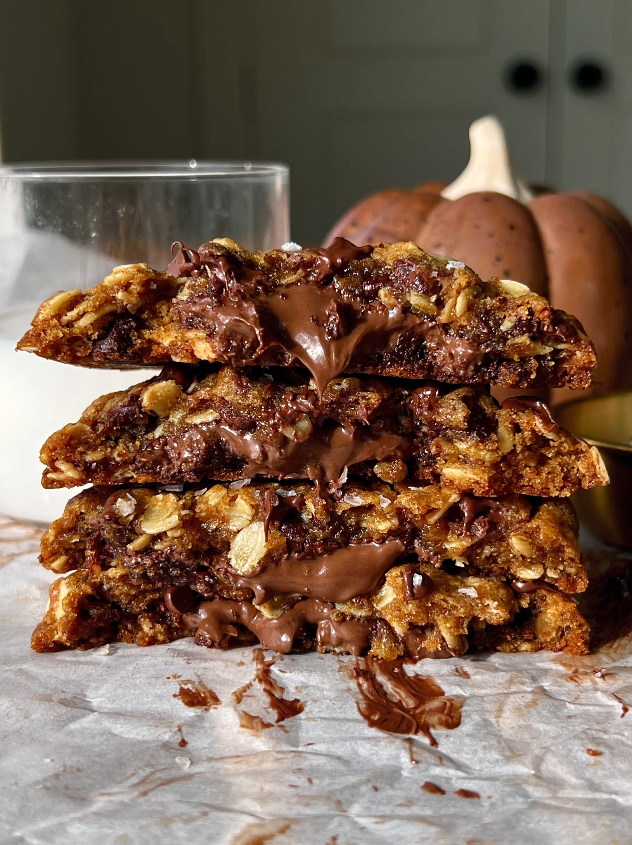 Nutella stuffed pumpkin oatmeal cookies with brown butter soft and gooey in the middle with perfectly crisp golden edges melty chocolate chips and a sprinkle of flaky sea salt.
