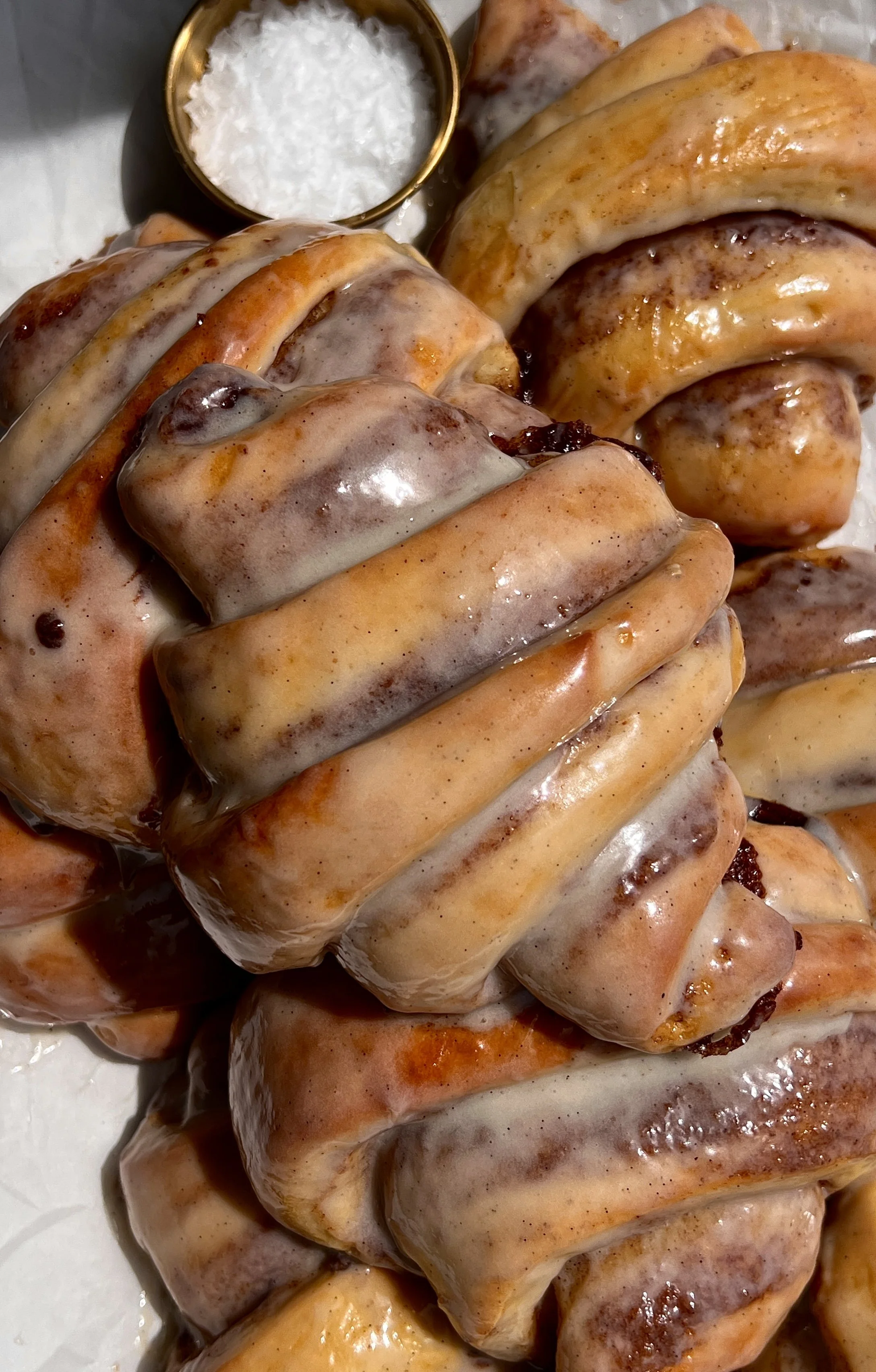 Close-up of cinnamon roll croissants with flaky layers and gooey cinnamon sugar filling.