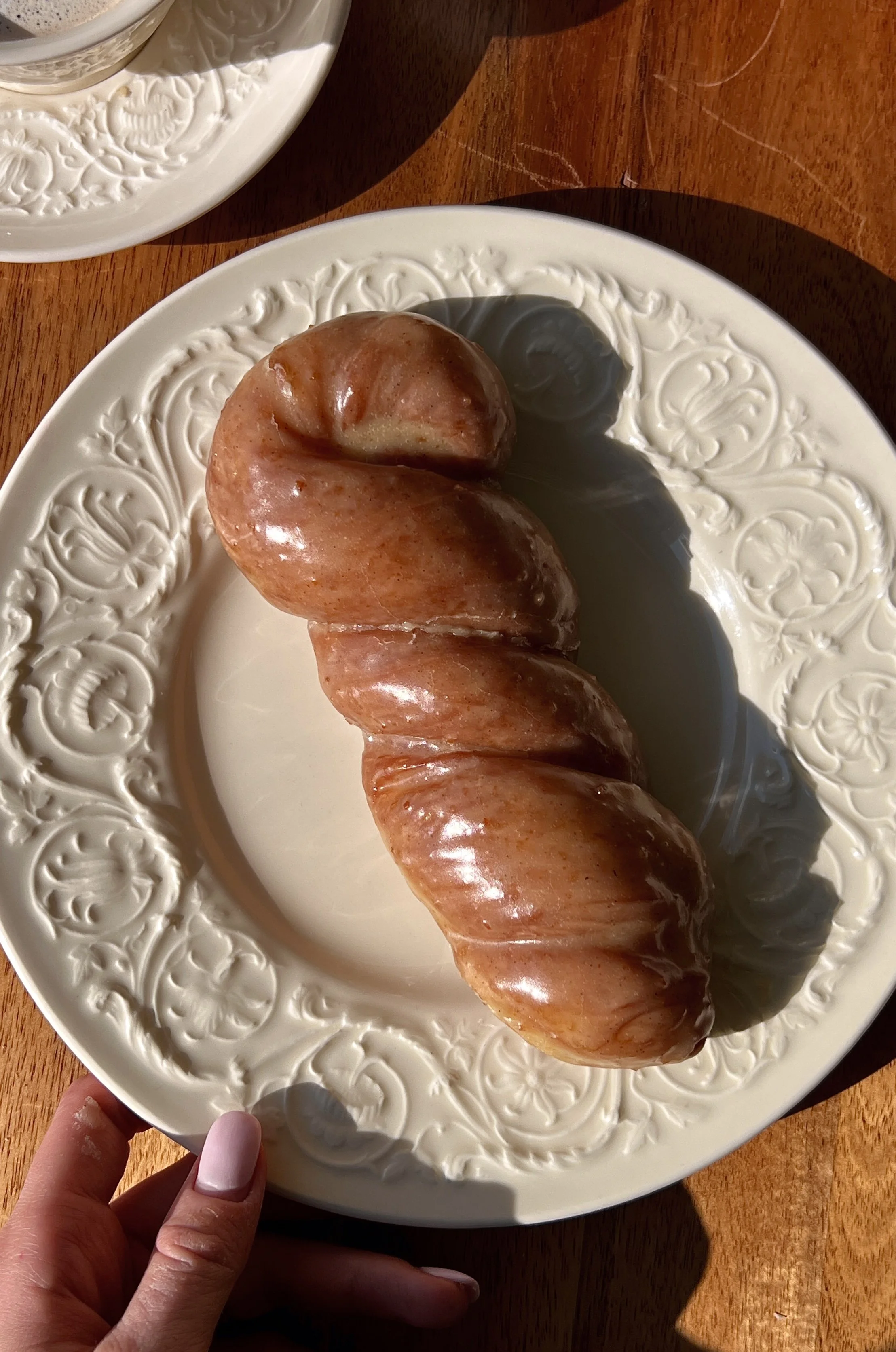 Soft and pillowy brown butter maple twist donuts made with tangzhong milk bread dough fried until perfectly golden and glazed in a rich brown butter maple glaze served warm with a hot cup of coffee.
