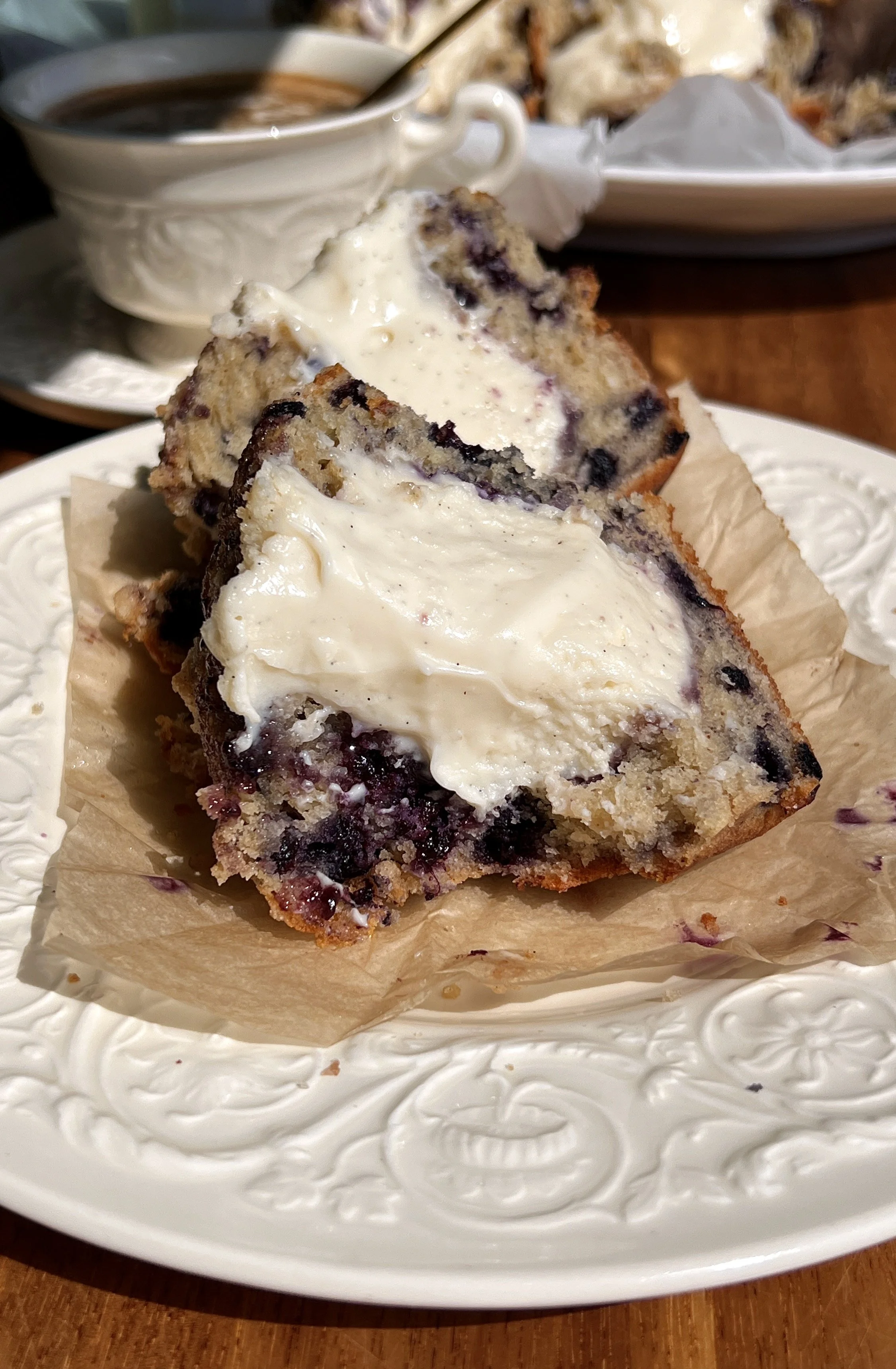 Close-up of blueberry cream cheese muffins with soft crumb, juicy blueberries, and buttery crumb topping.