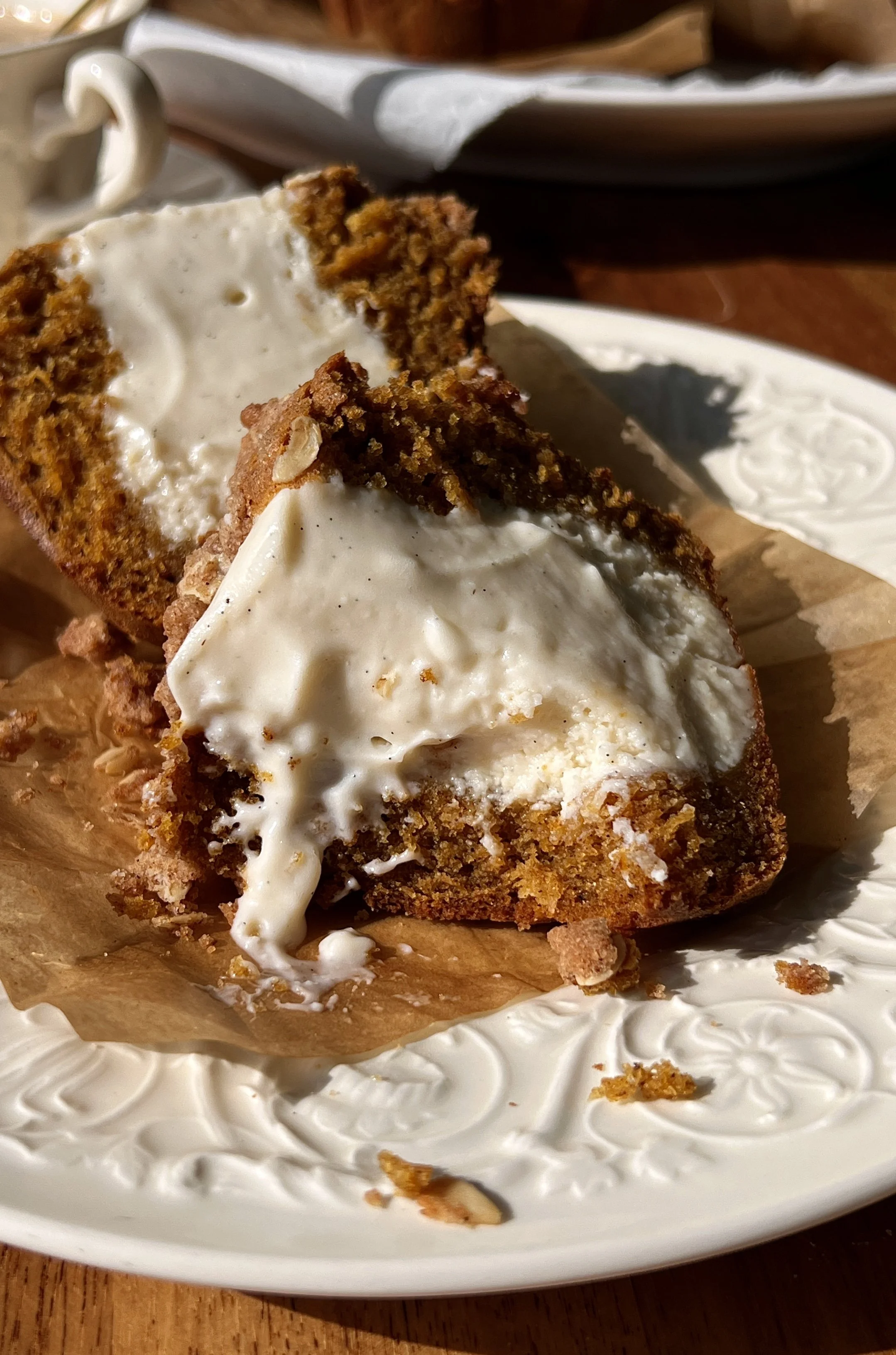 Soft and fluffy bakery-style pumpkin cream cheese muffins with brown butter packed with warm spiced pumpkin flavor and smooth tangy cream cheese filling finished with a buttery oat streusel served warm with a hot cup of coffee.