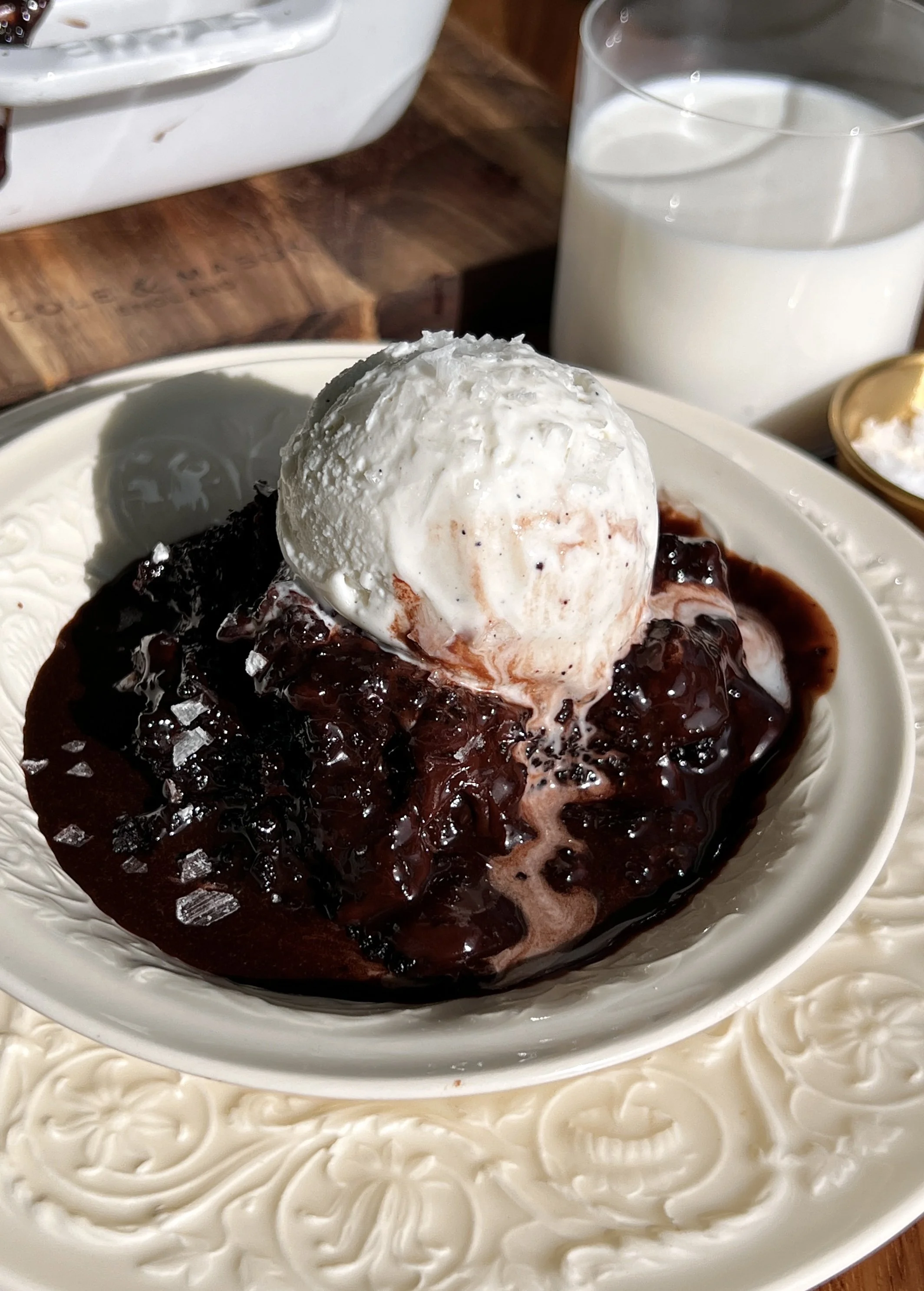 Hot chocolate fudge cake topped with chocolate ganache and served with vanilla ice cream and flaky sea salt.
