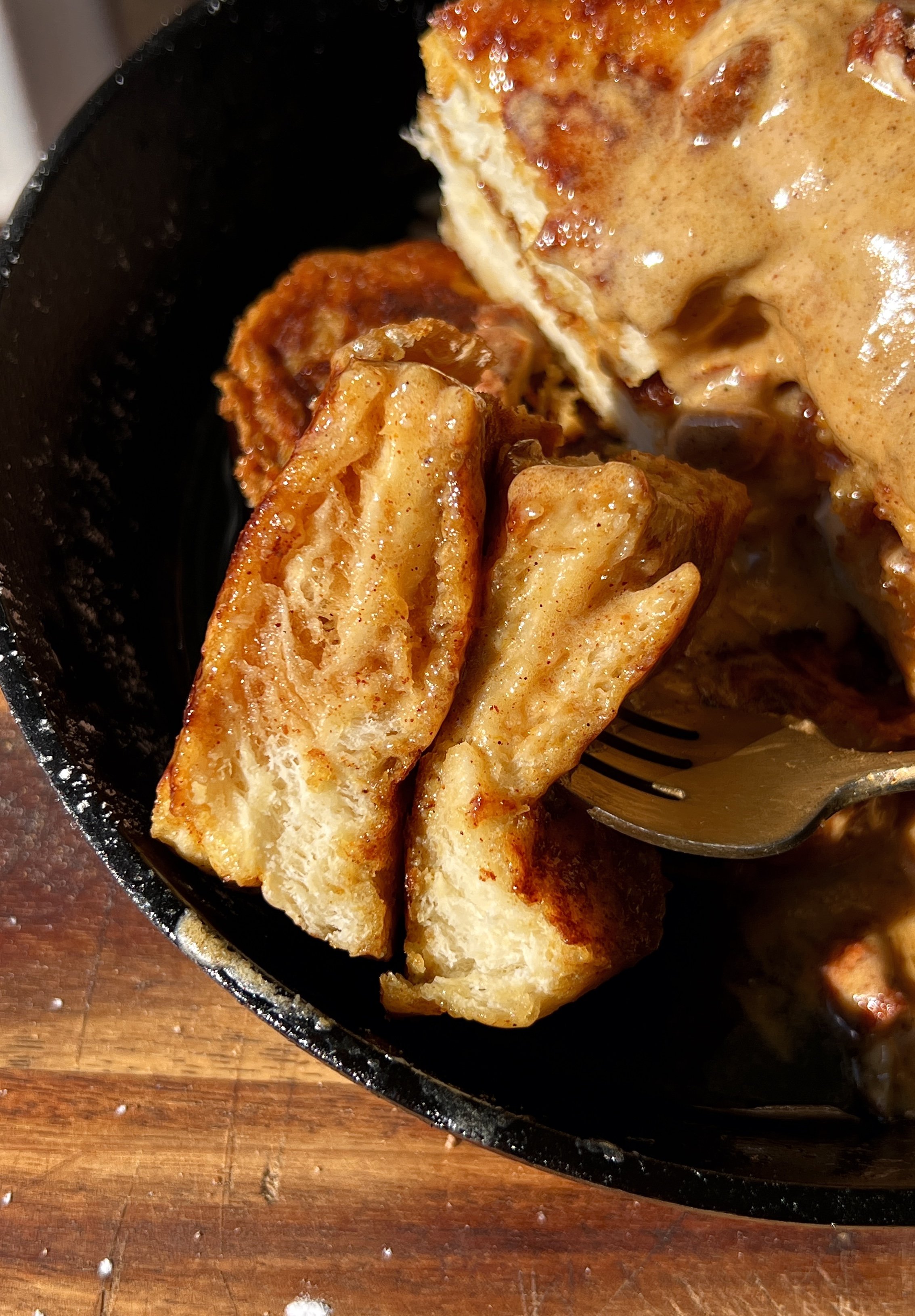 Close-up of a golden pumpkin spice french toast slice showing the perfectly golden exterior and soft custardy pumpkin spice center.