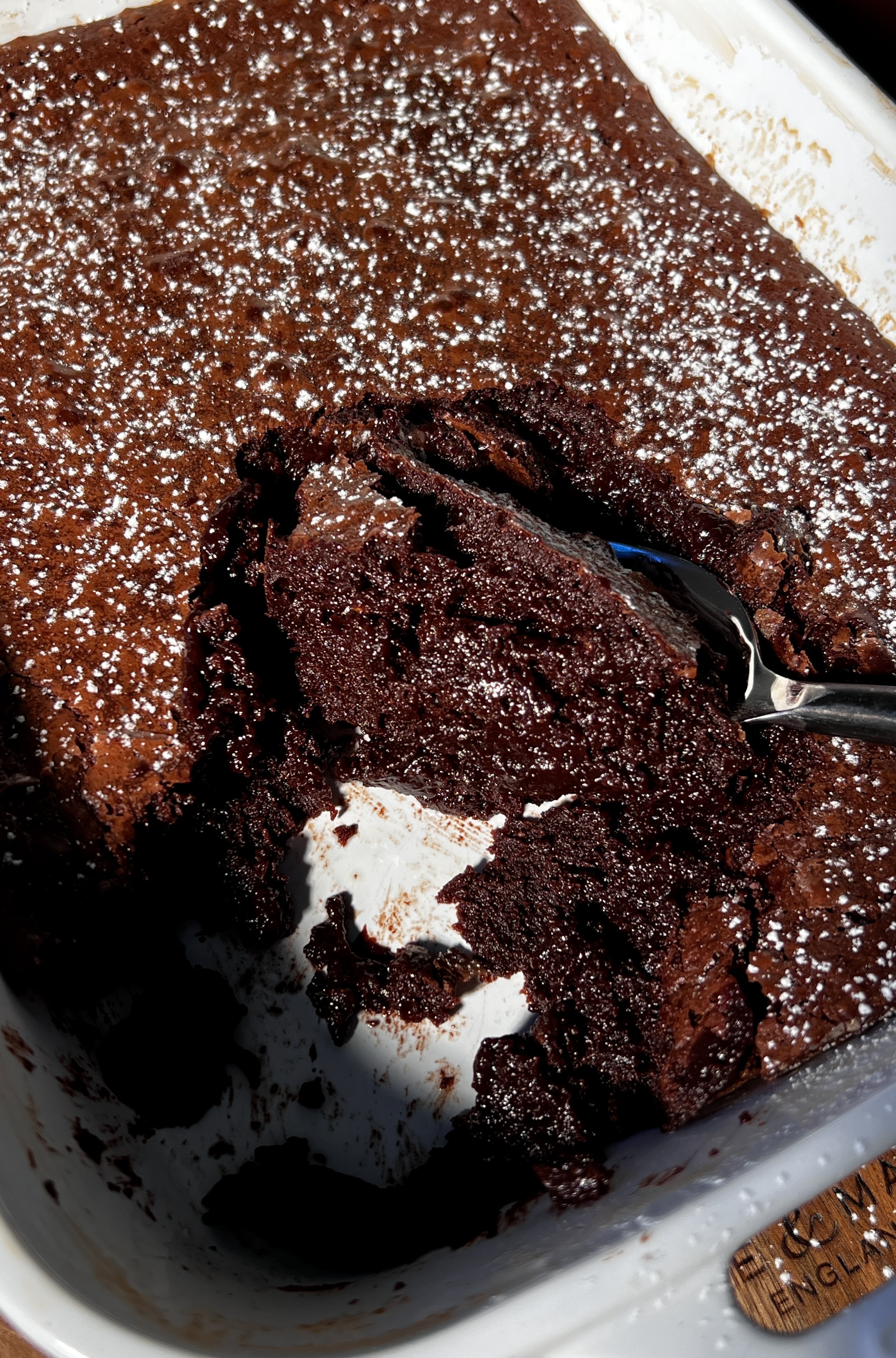 Warm deep dish brown butter molten lava cake with a gooey chocolate center, topped with vanilla ice cream and hot fudge.