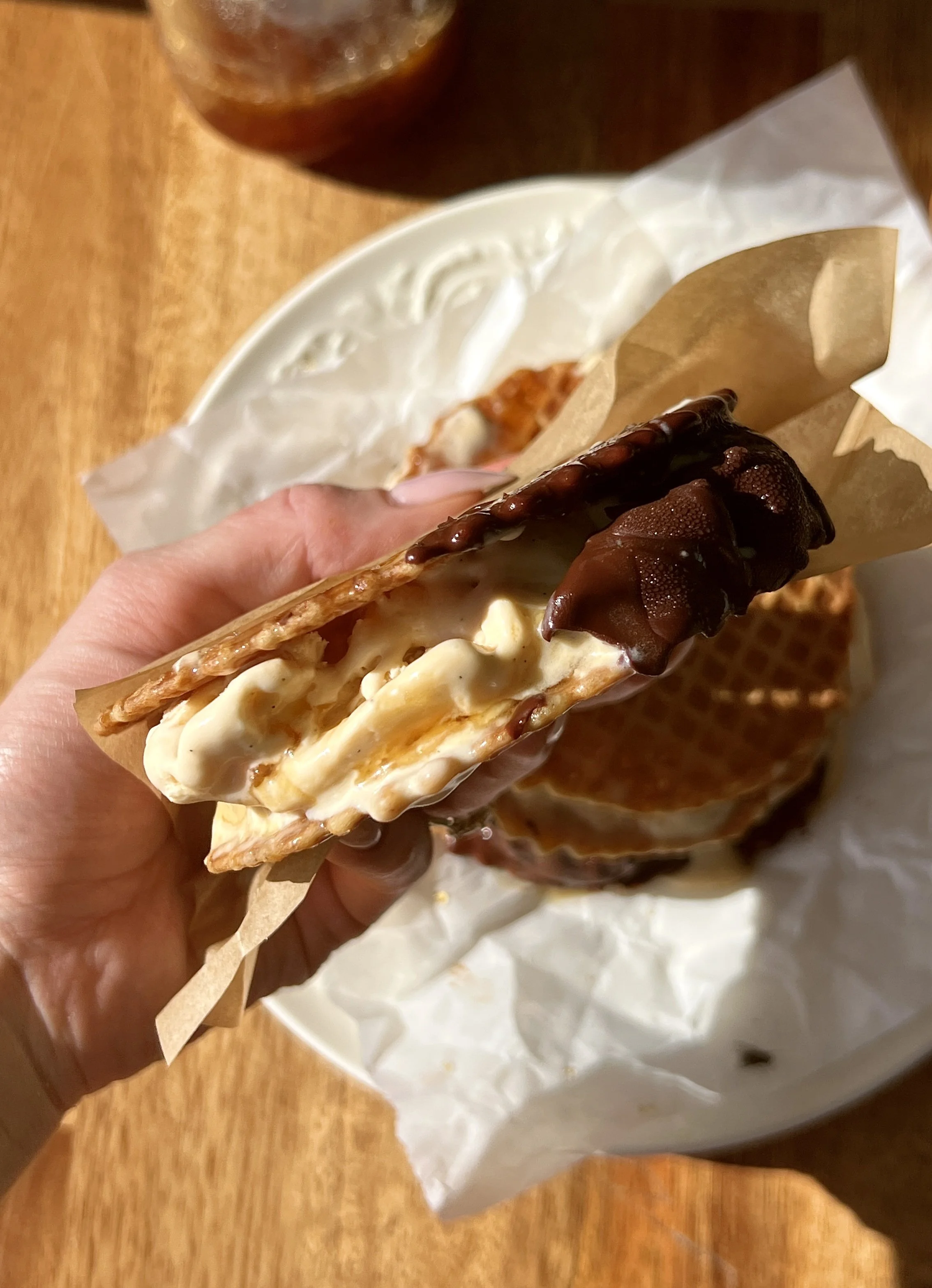 Dreamy salted maple swirl ice cream sandwiches made with rich maple custard ice cream and a thick salted maple syrup swirl sandwiched between buttery waffle cookies and dipped in chocolate.