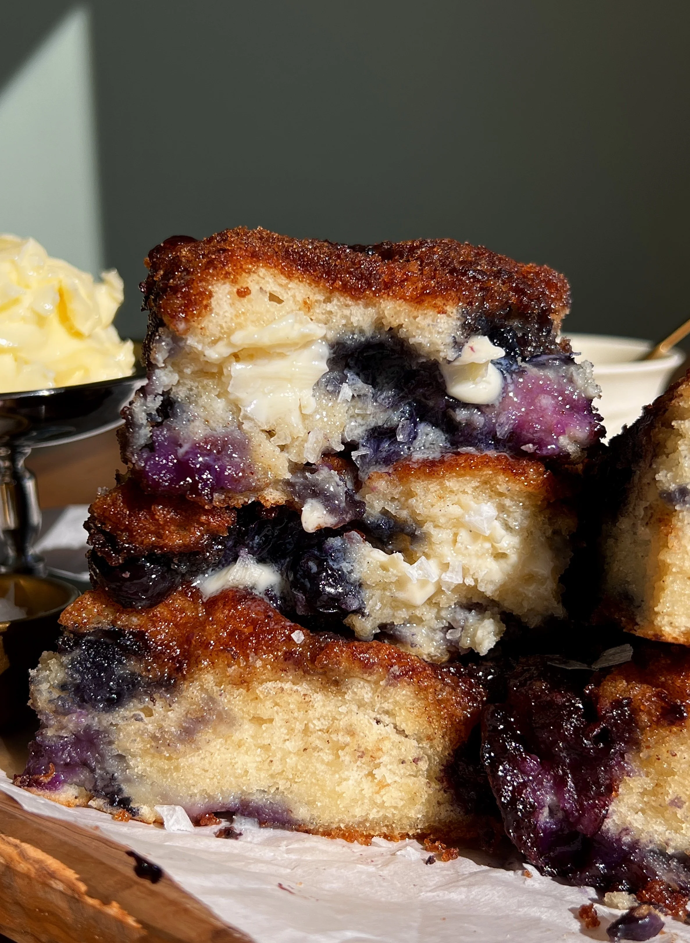 Cinnamon crunch blueberry butter swim biscuits baked in butter with golden tops and juicy blueberries.