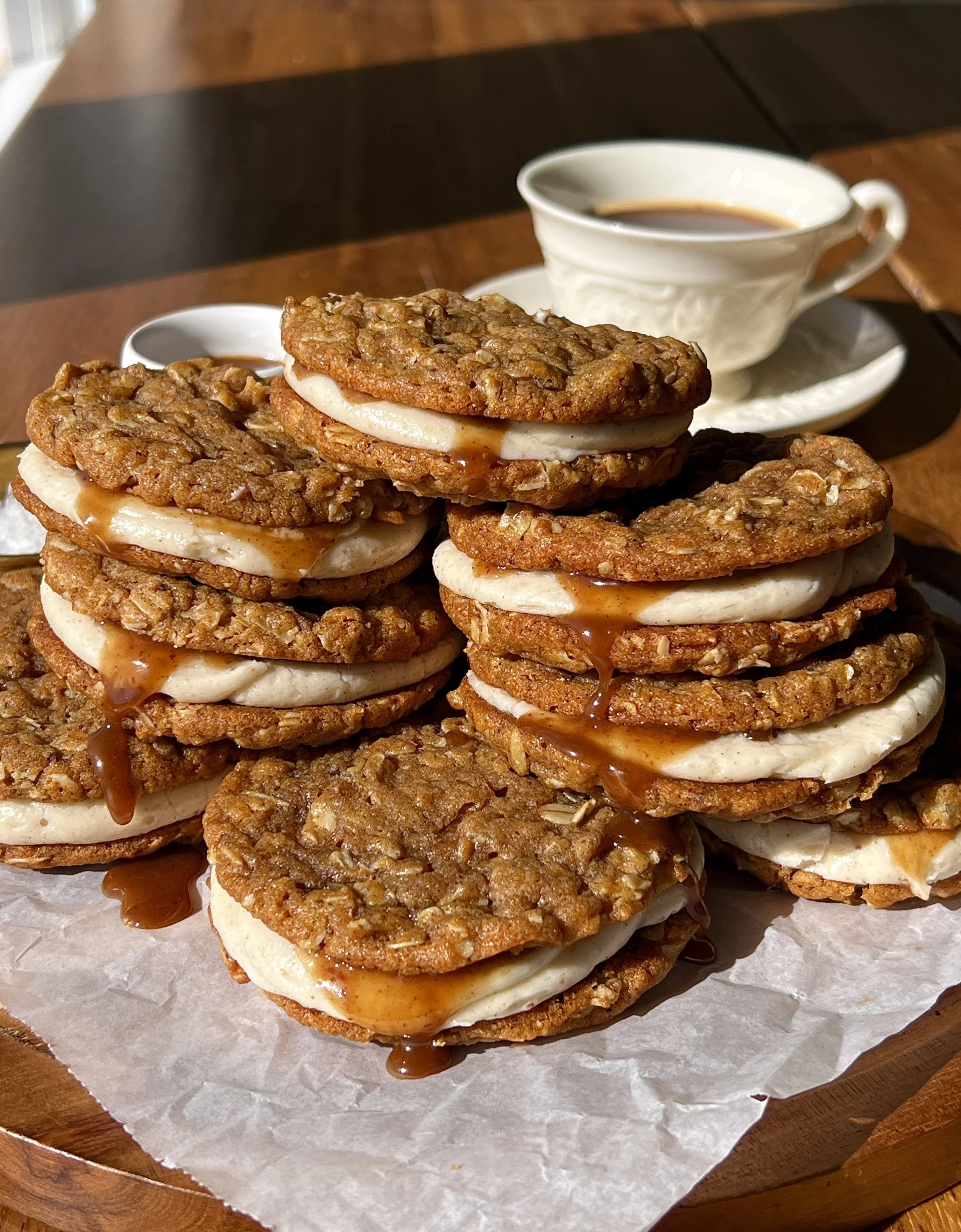 Brown butter sweet potato oatmeal cream pies with a lush brown butter cream cheese filling and salted maple caramel sandwiched between two soft and chewy sweet potato oatmeal cookies.