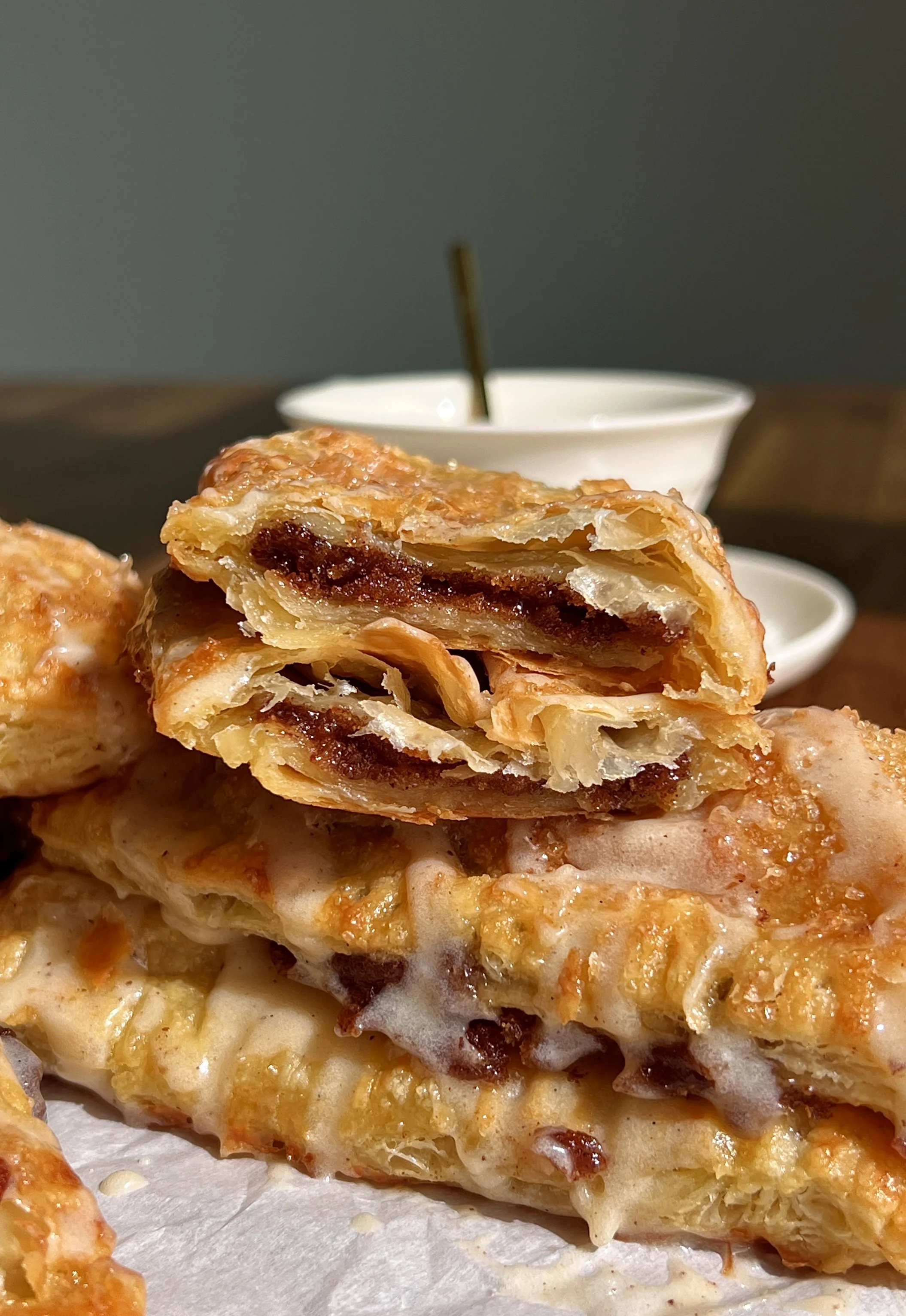 Flaky homemade cinnamon roll toaster strudels filled with gooey cinnamon sugar filling and drizzled with brown butter maple cream cheese glaze.