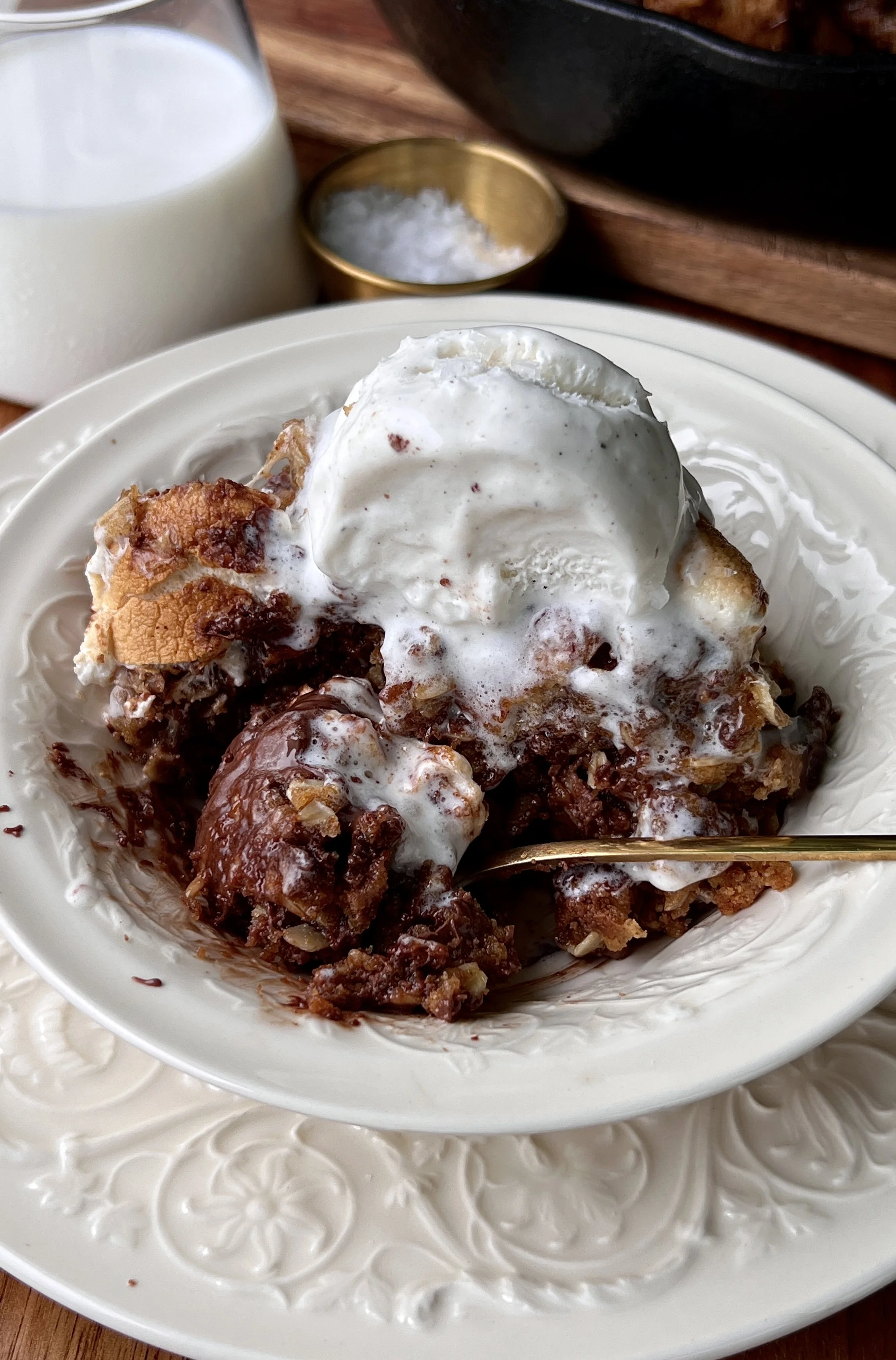 Soft and gooey peanut butter s'mores oatmeal cookie skillet made with brown butter, melty chocolate, toasted marshmallows, and crushed graham crackers served warm with a scoop of vanilla ice cream and flaky sea salt.