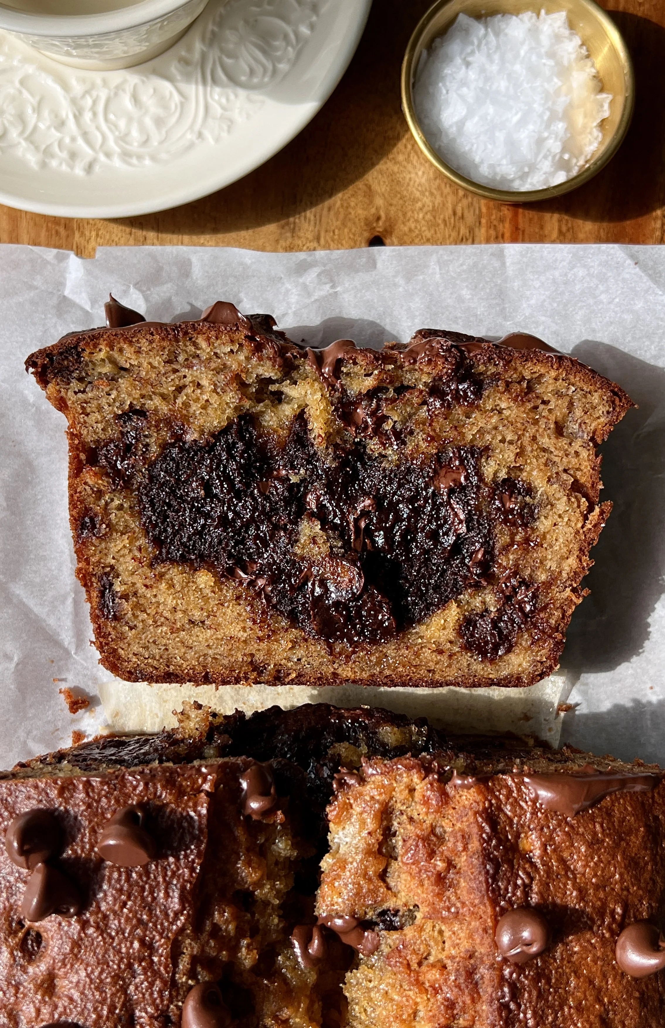 Close-up of a slice of brownie stuffed banana bread showing the soft fluffy banana bread exterior and rich fudgy brownie filling melting throughout.