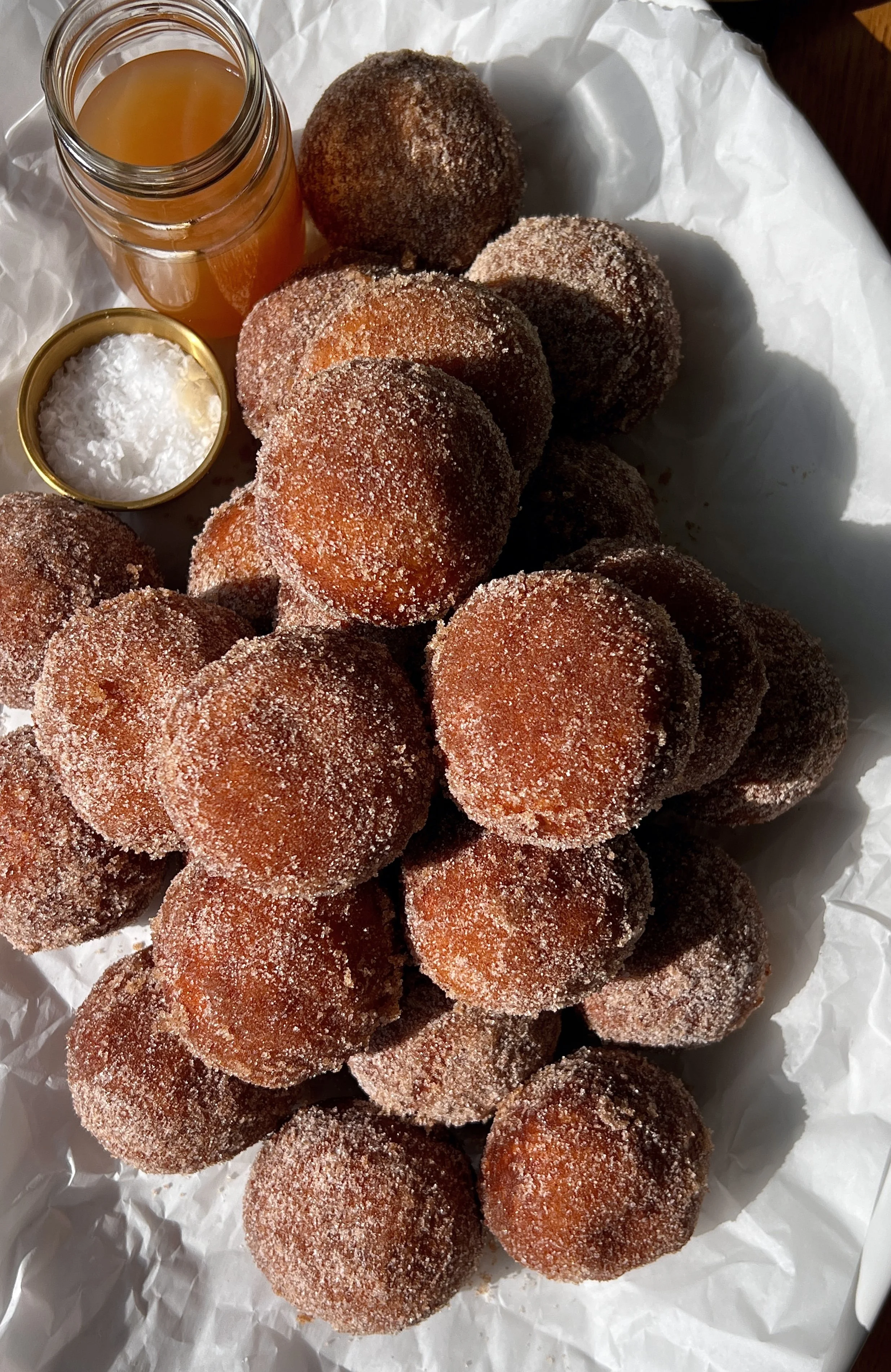 Apple cider cinnabon delights rolled in cinnamon sugar with a sweet tangy cream cheese filling and apple cider butter soak served warm.
